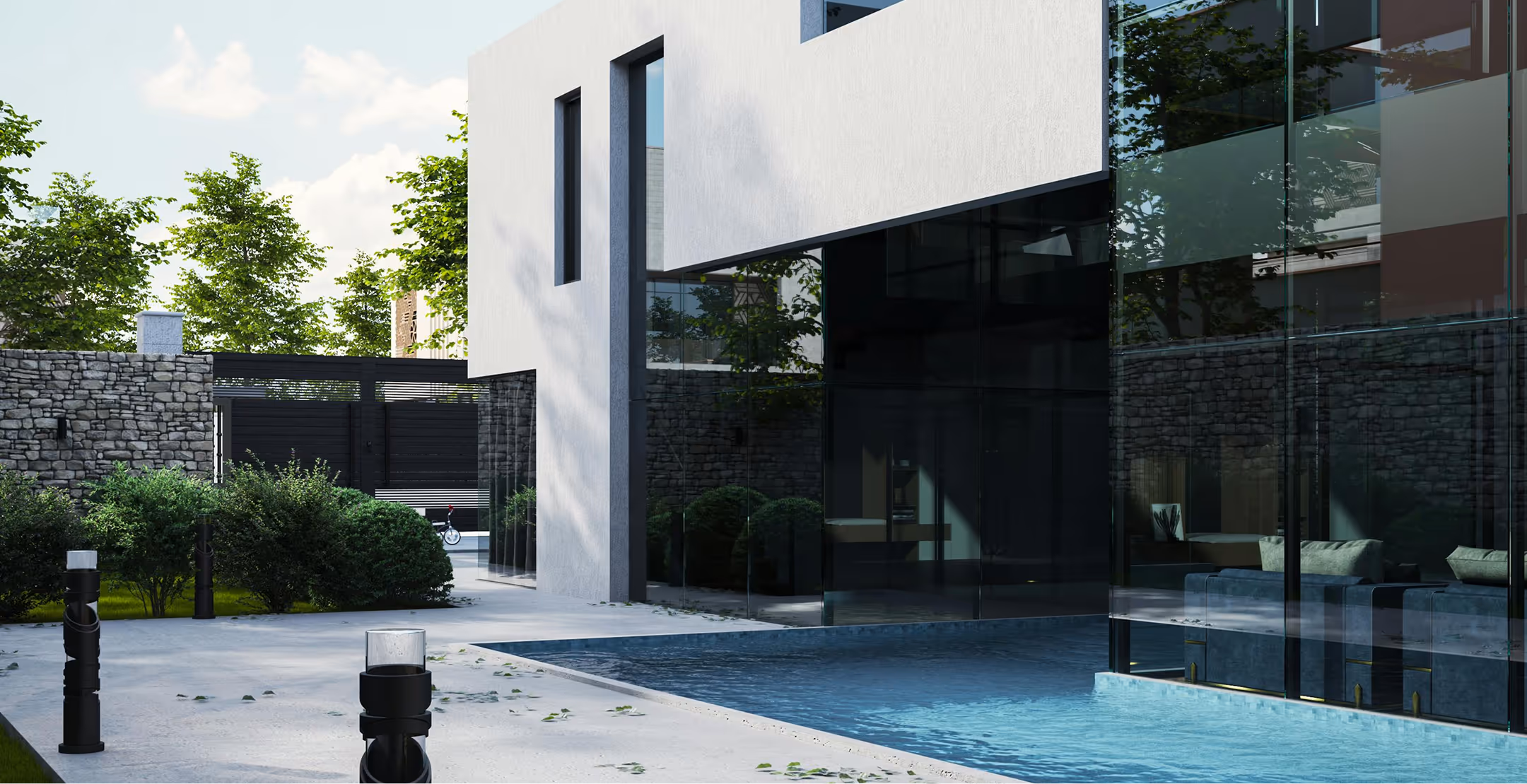 Modern building with large glass walls next to a swimming pool and surrounding greenery.