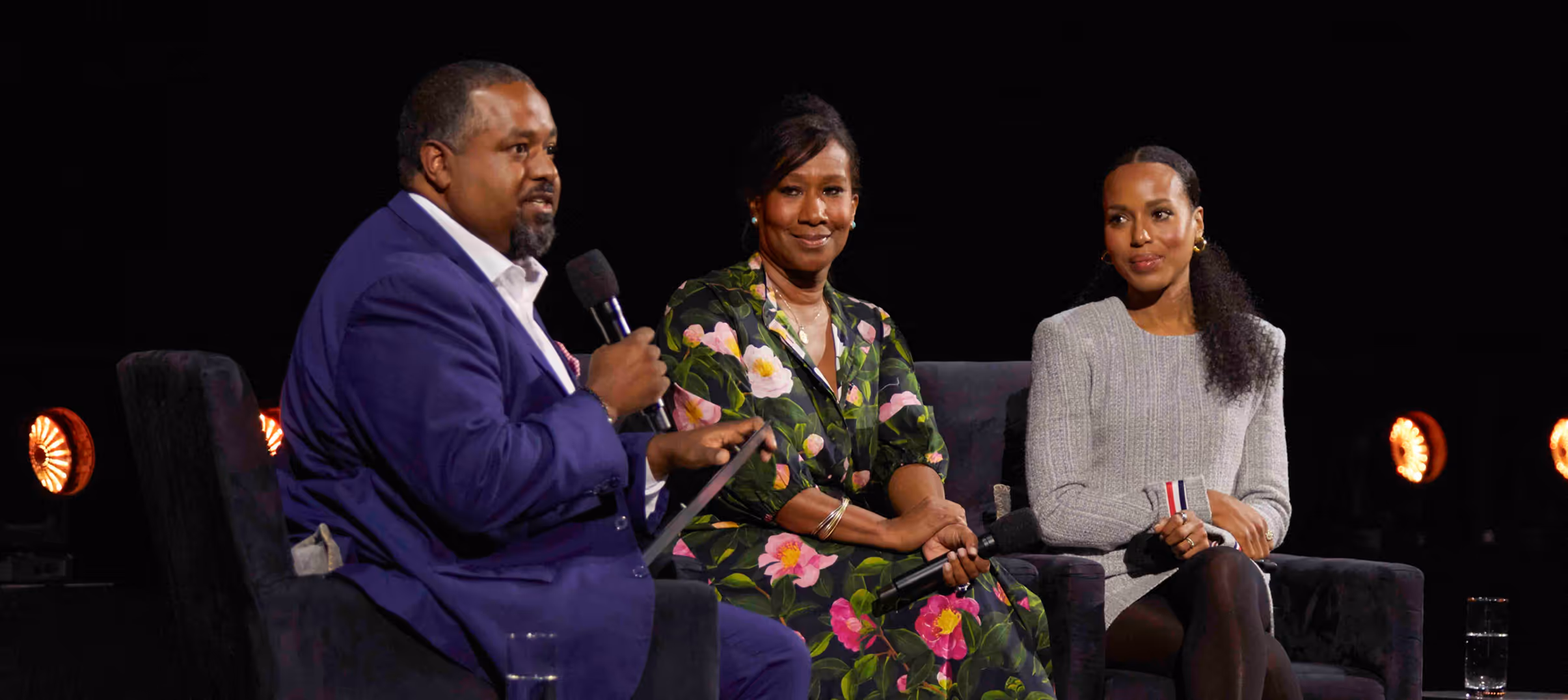 Panel discussion for The HISTORY Channel featuring three speakers seated onstage.