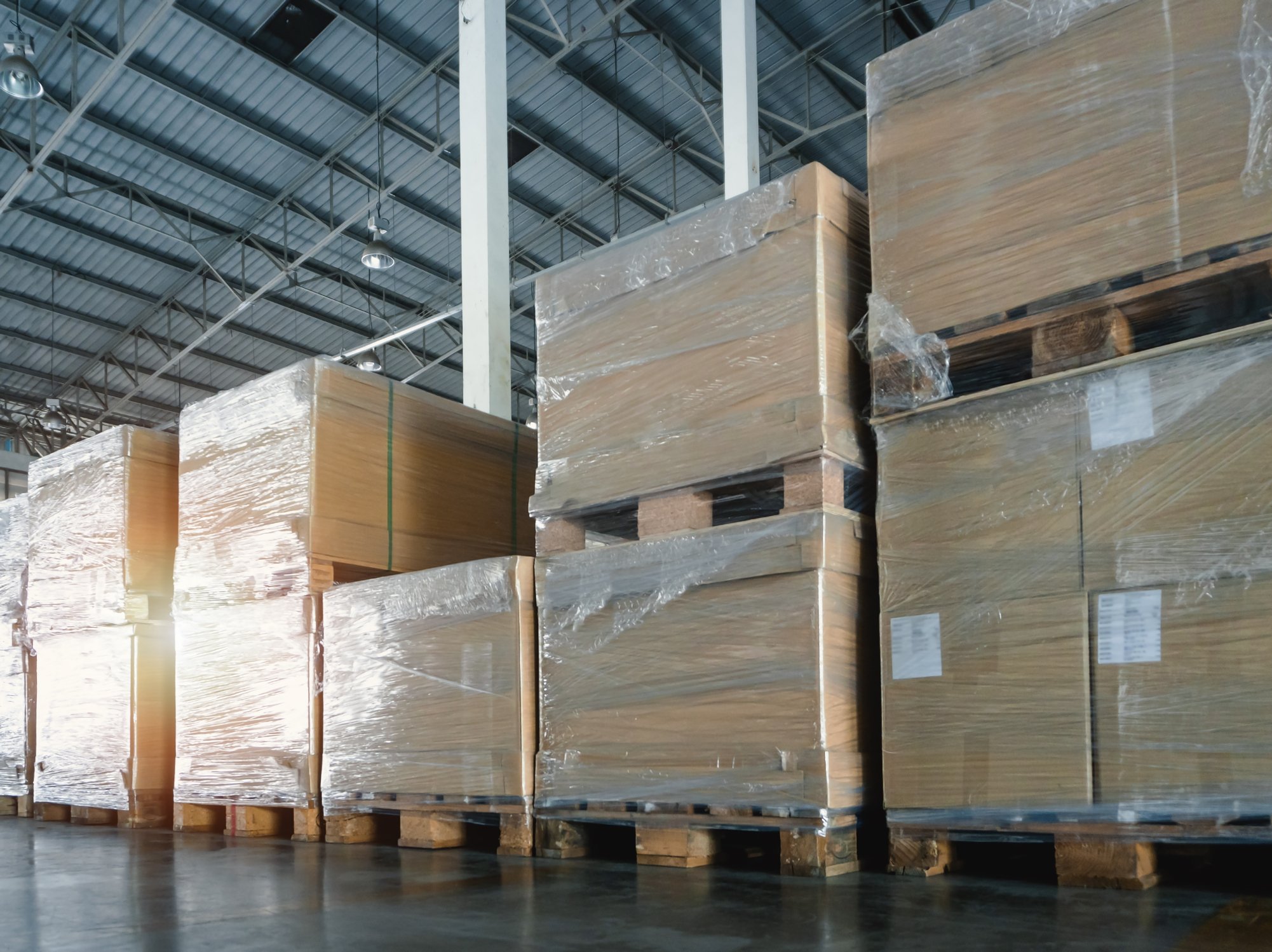 Shrink-wrapped pallets of boxed freight stacked in a warehouse, storage and transloading coordinated by AEEM Shipping in Southern California