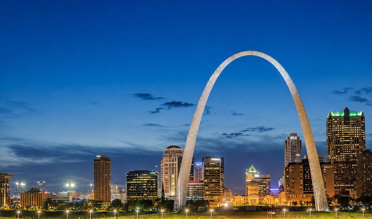 Gateway Arch rising over the St. Louis skyline at blue hour with the Mississippi River in the foreground, Missouri