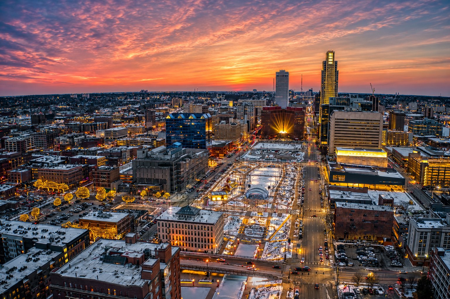 Aerial view of downtown Omaha at sunset with a lit winter park and the skyline towers, Nebraska