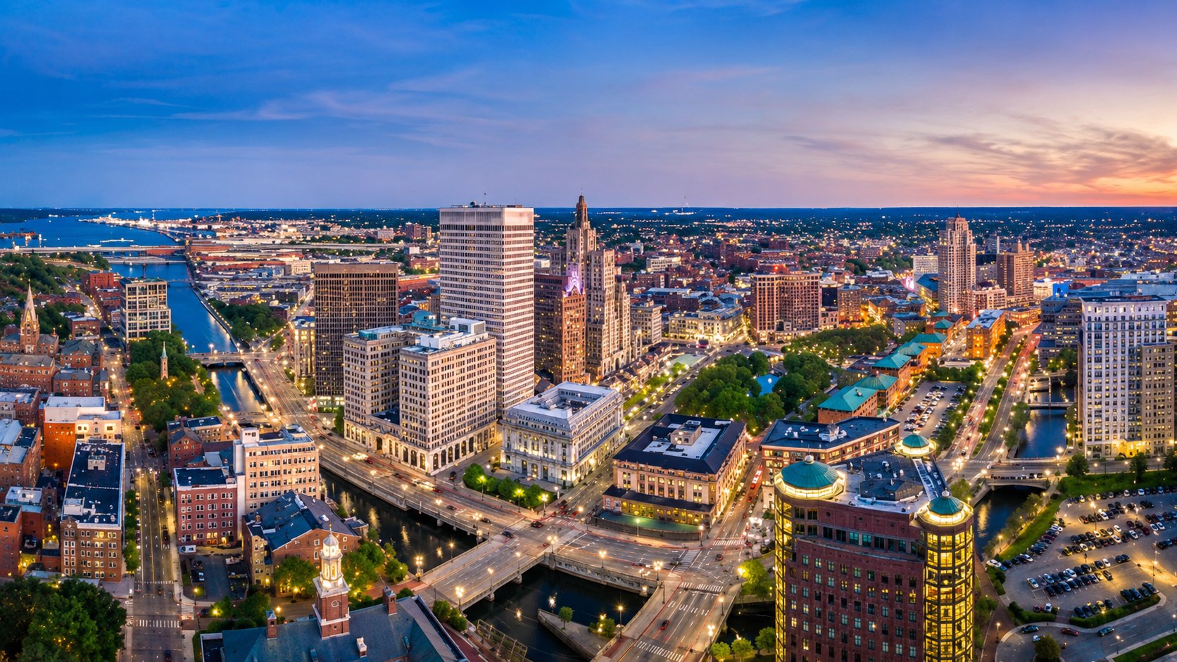Aerial view of downtown Providence at dusk with its rivers, bridges, and the lit skyline, Rhode Island