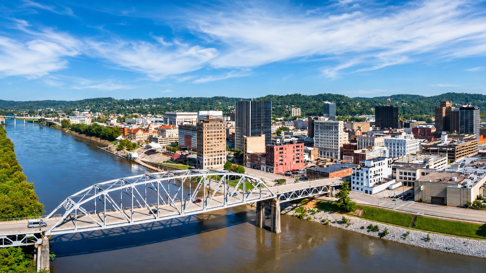 Aerial view of downtown Charleston West Virginia with a steel truss bridge crossing the Kanawha River