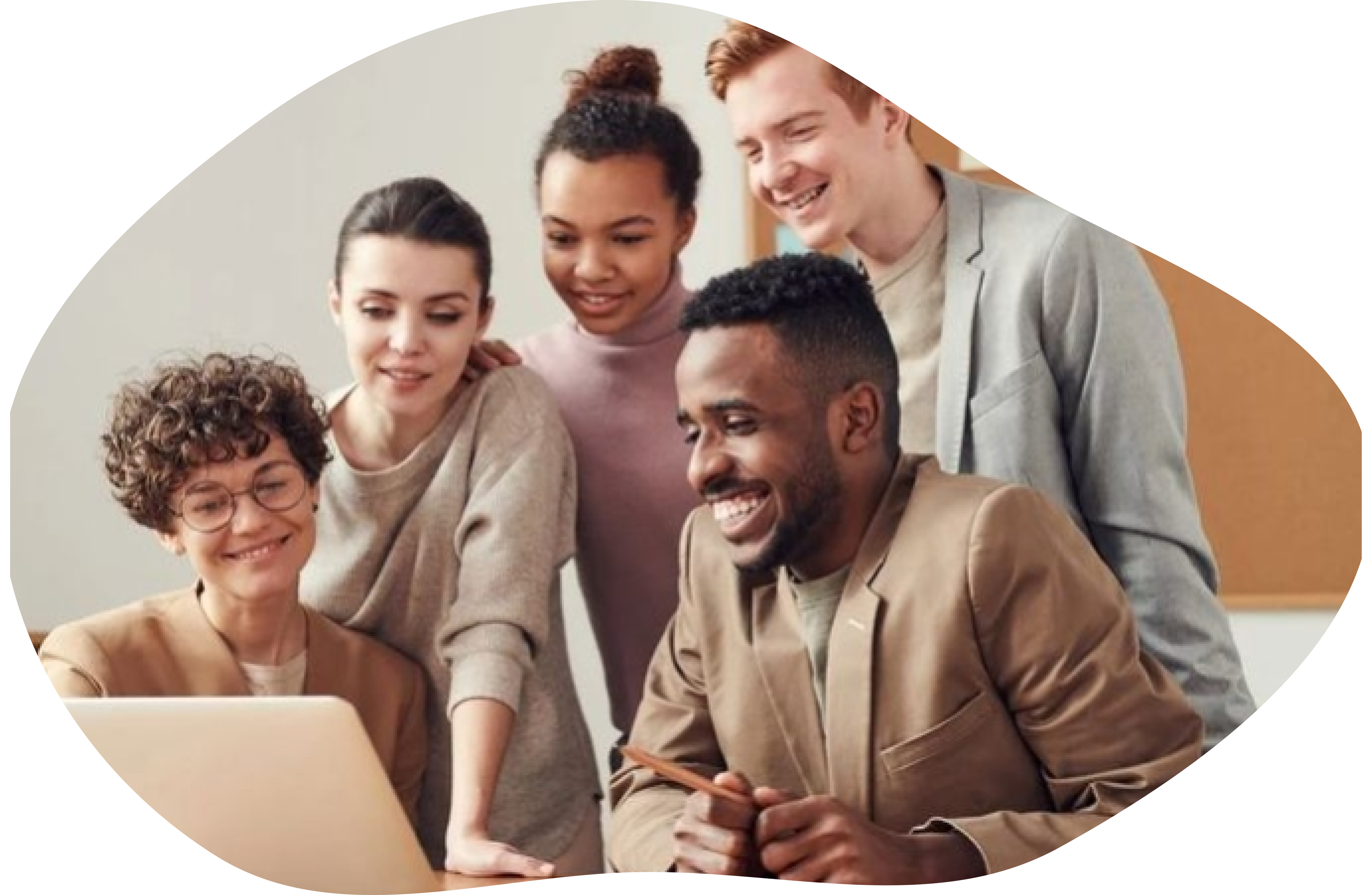 Group of four diverse young professionals smiling and looking at a laptop screen together.