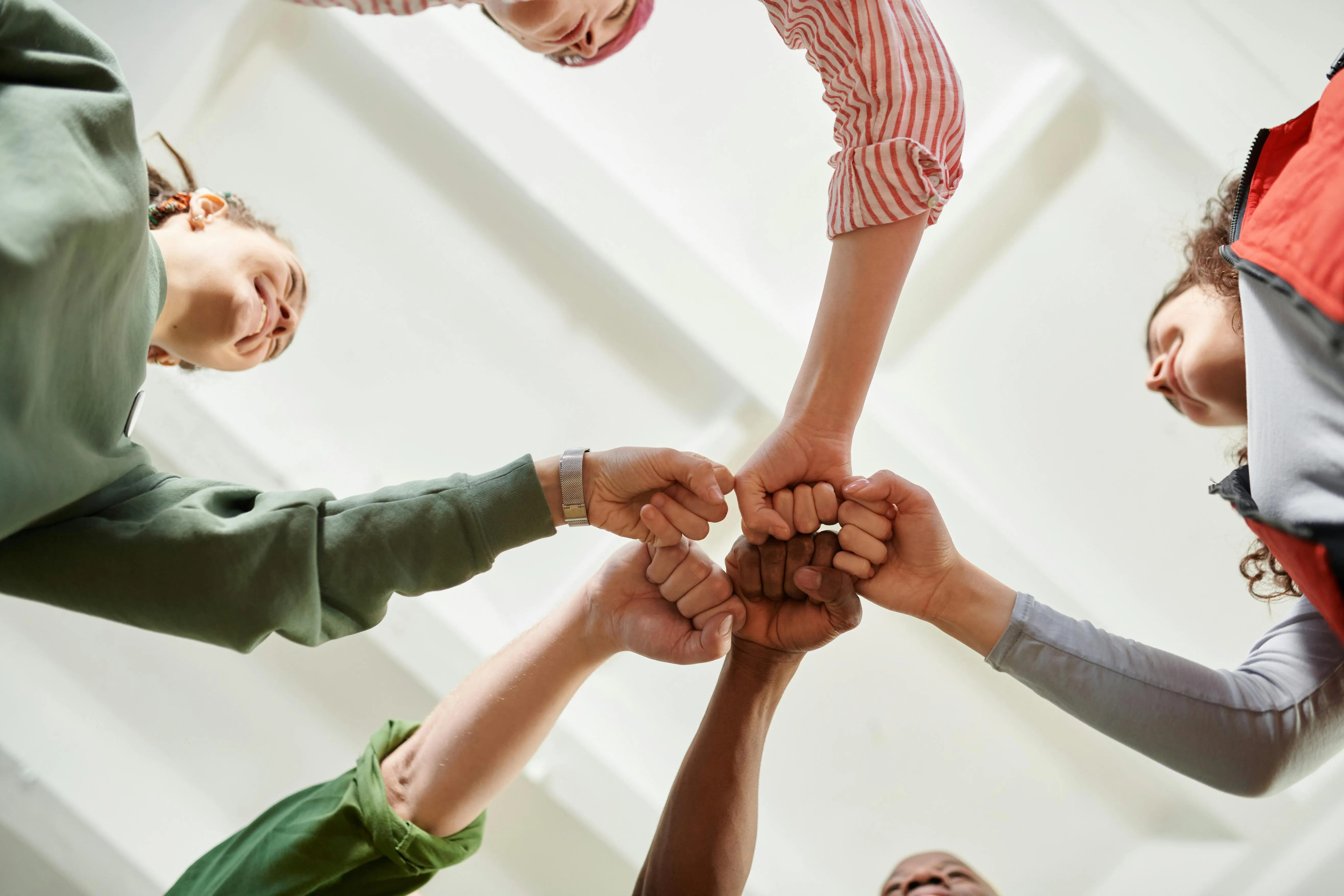 A group of people giving each other fist bumps