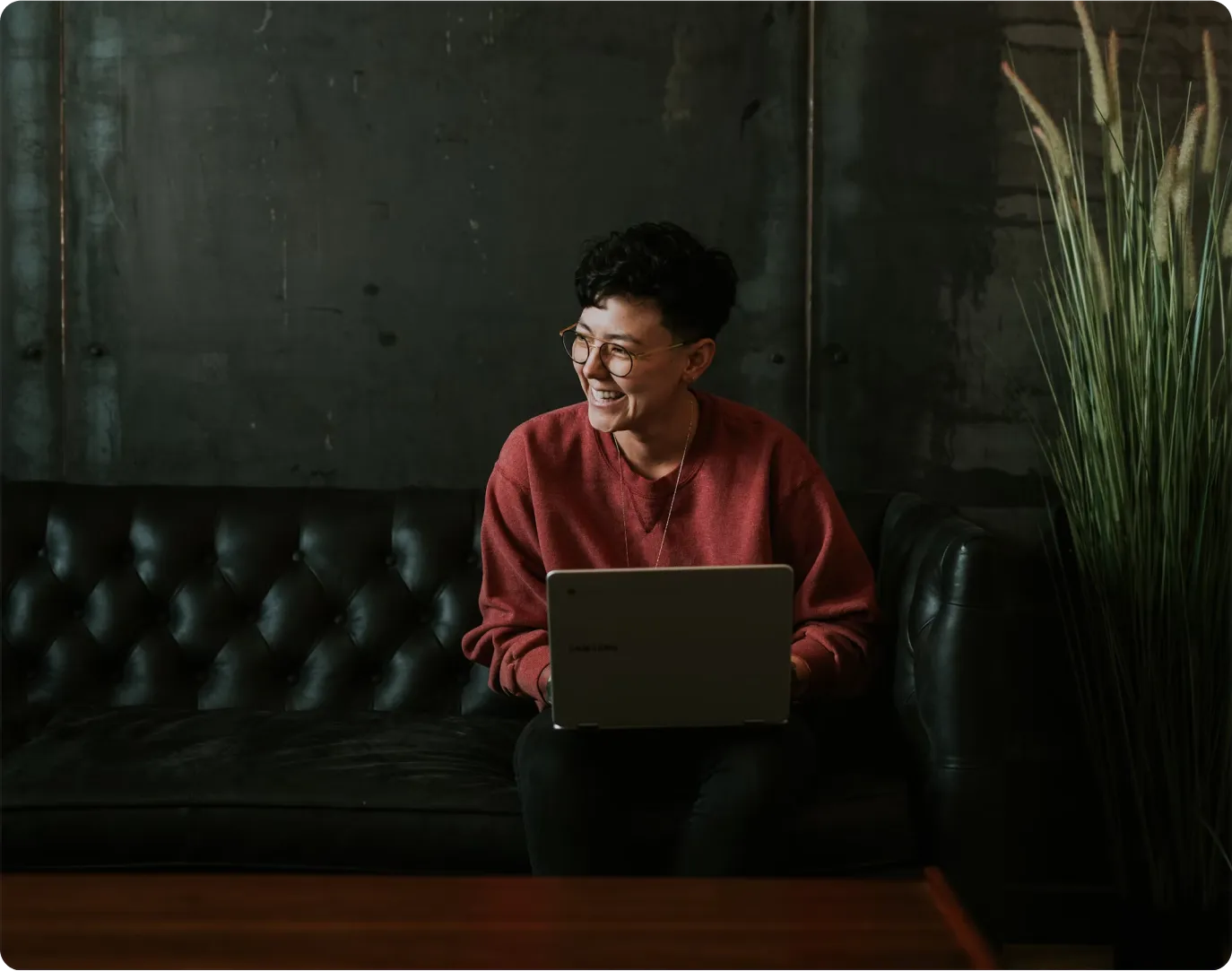 A smiling man holding his laptop