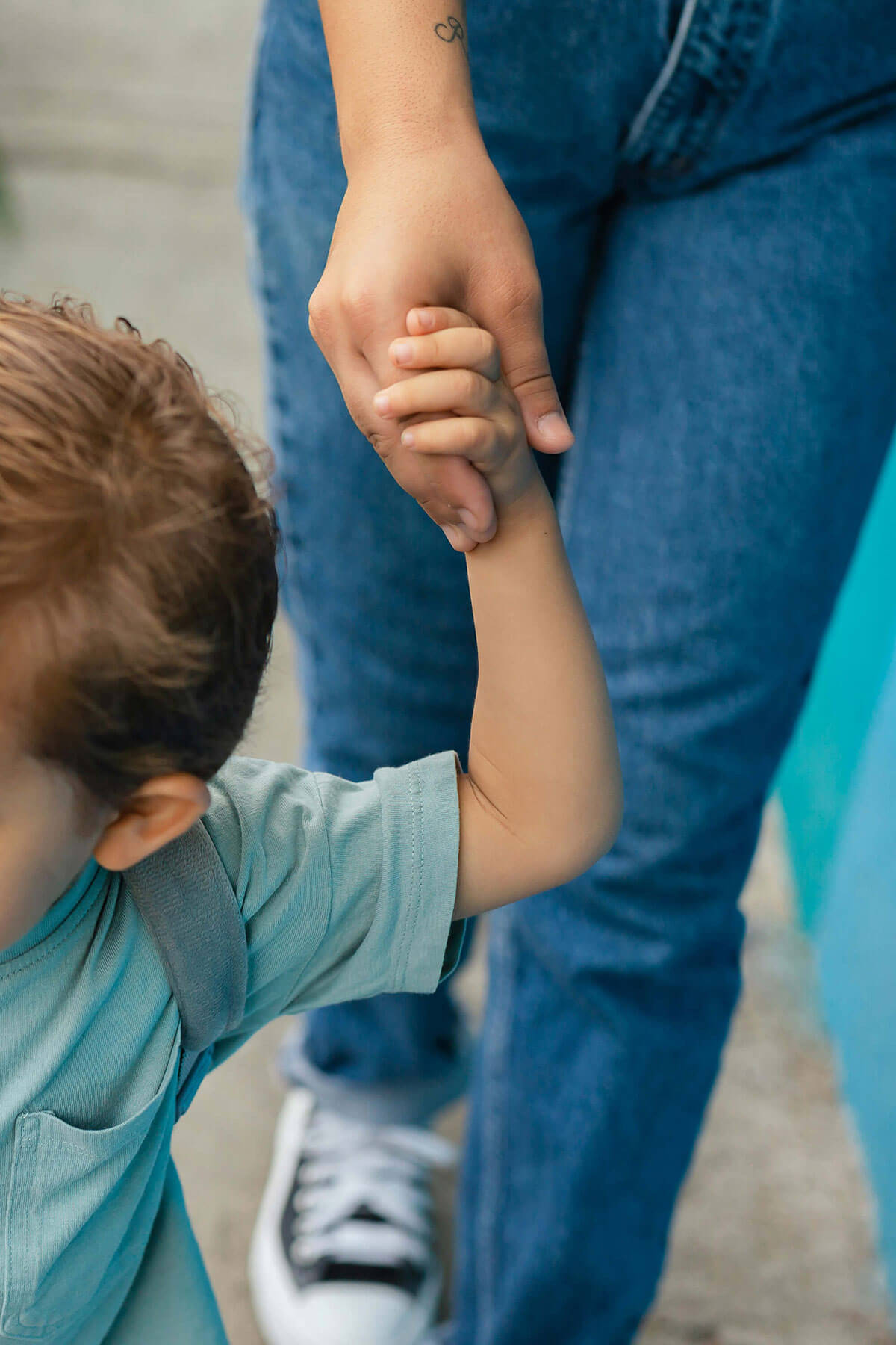 Förälder håller barn i hand