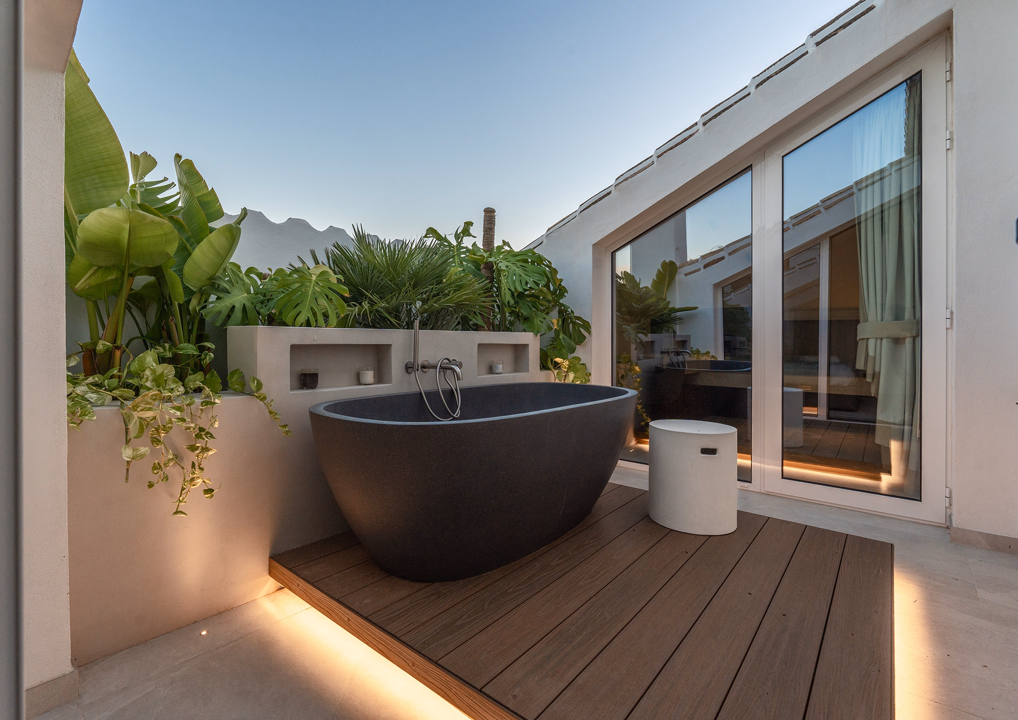 Luxury outdoor bathtub on the terrace of Las Lolas penthouse with mountain backdrop