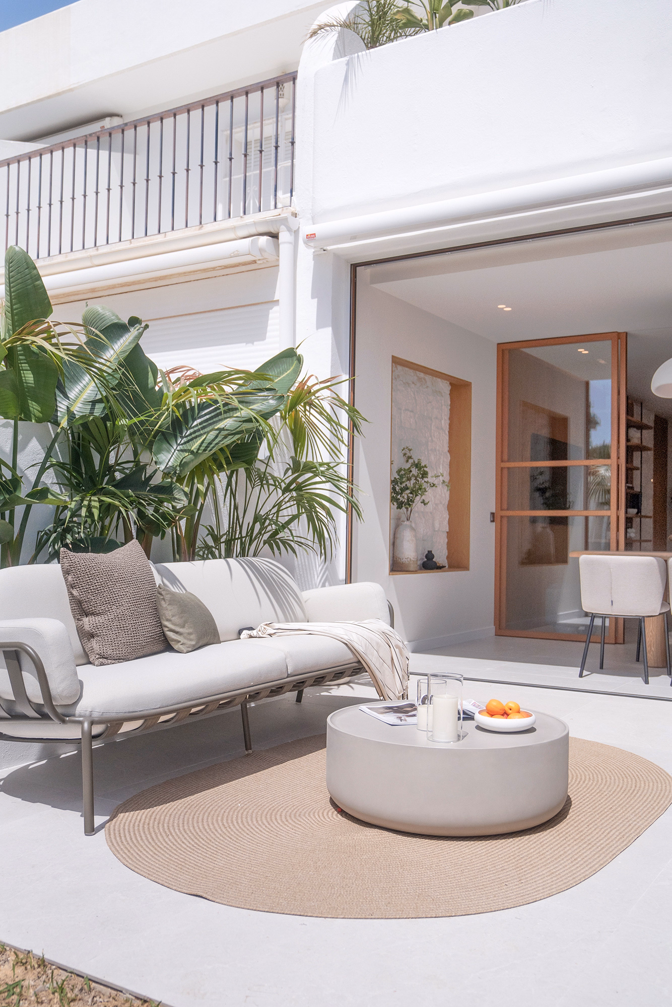 Outdoor dining terrace at CASA ILIA with garden and pool views