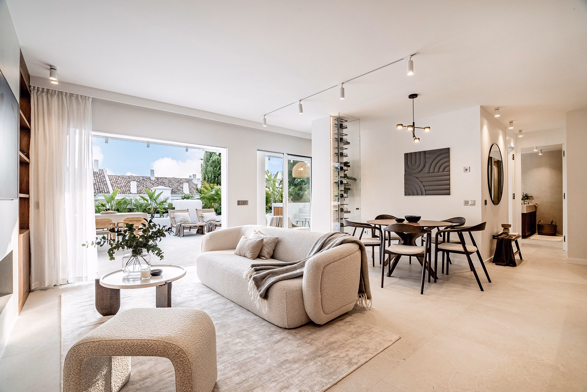 Open-plan living and dining area with elegant finishes at Casa Louneh in Marbella, Spain