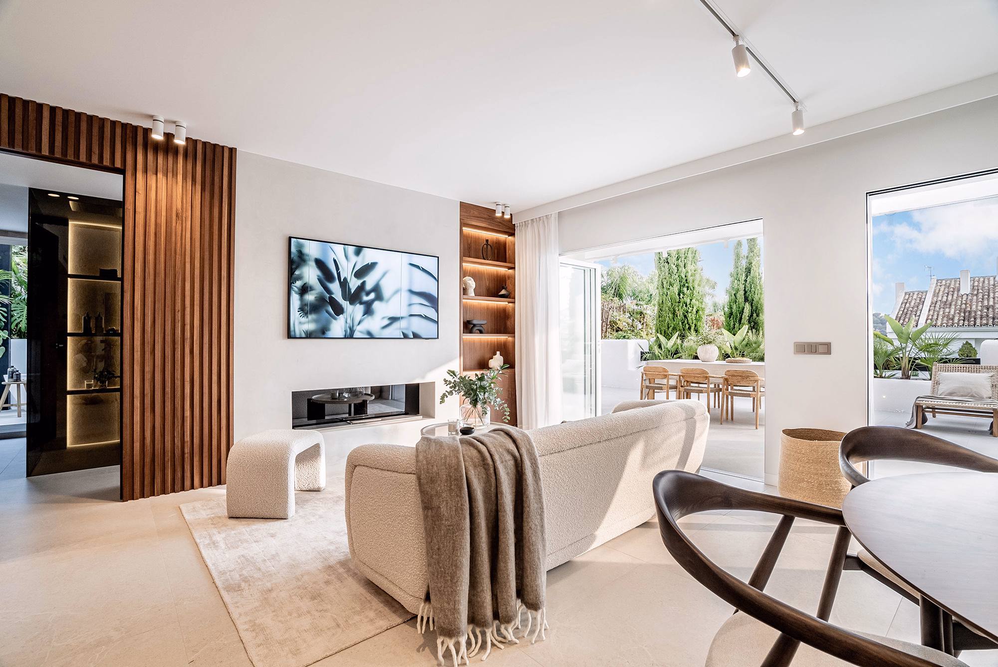 Living room with walnut wood accents and natural tones in Casa Louneh apartment, Aloha, Marbella