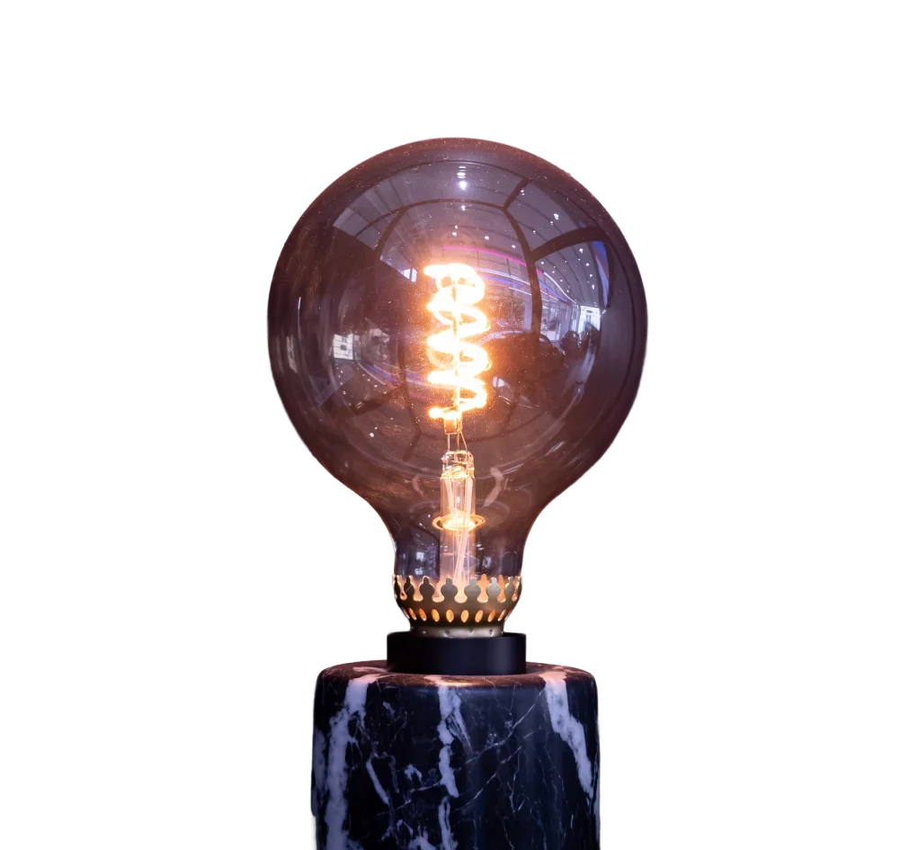 A lightbulb glowing on podium or stone block