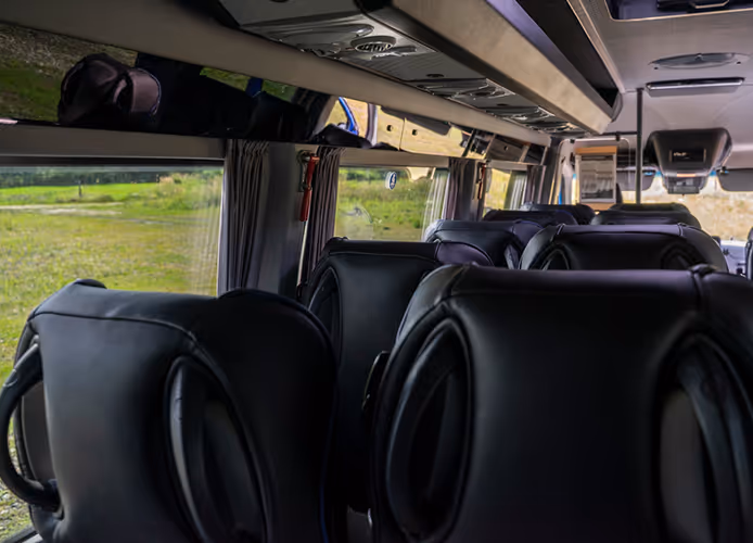 Przestronne i komfortowe wnętrze busa Mercedes Sprinter 519 z rzędami wygodnych foteli, gwarantujące wygodę podczas podróży na Dolnym Śląsku.