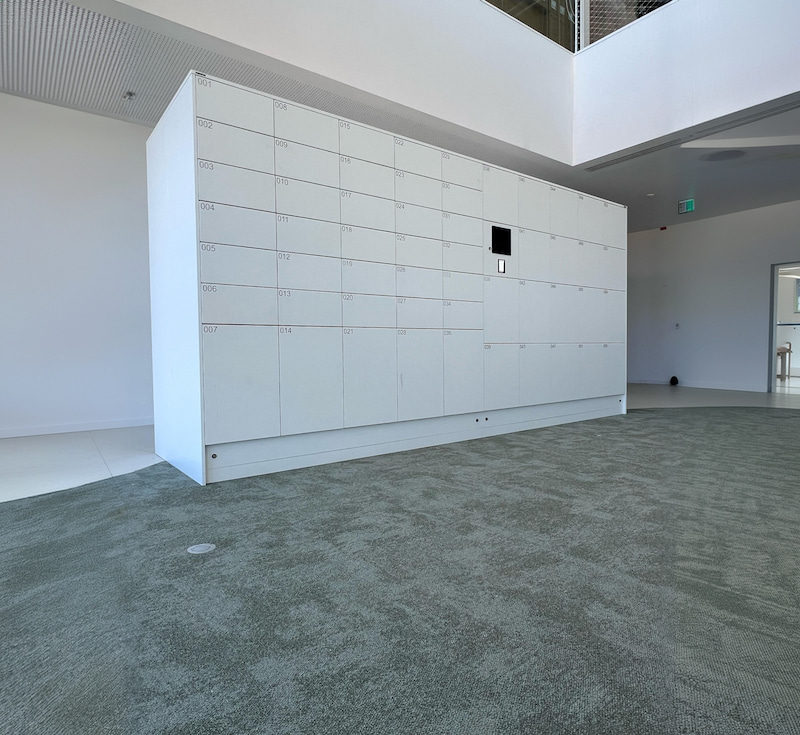 White Luvio parcel locker wall at Thales