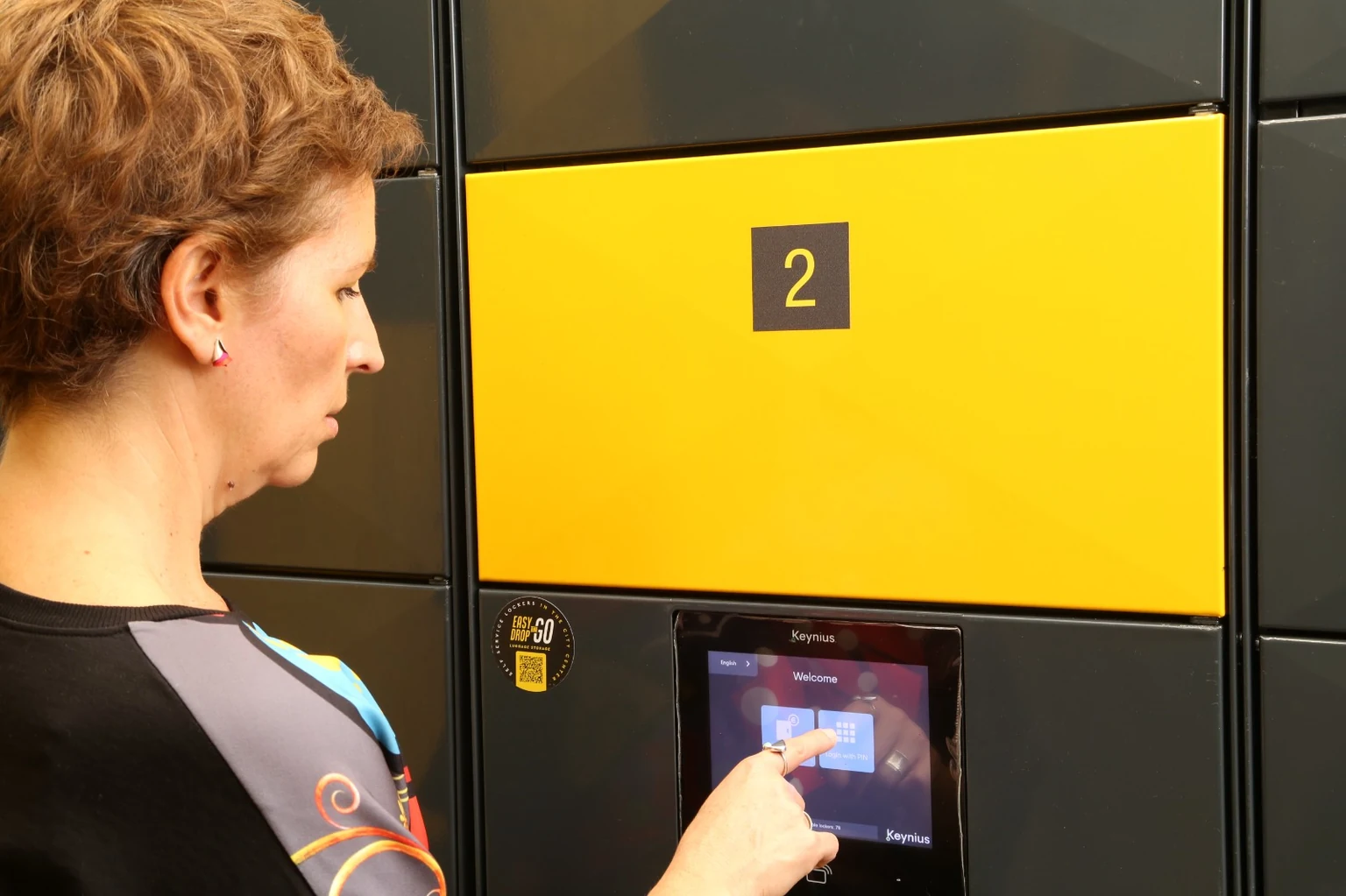 Customer using the Smarty touchscreen at Easy Drop & Go