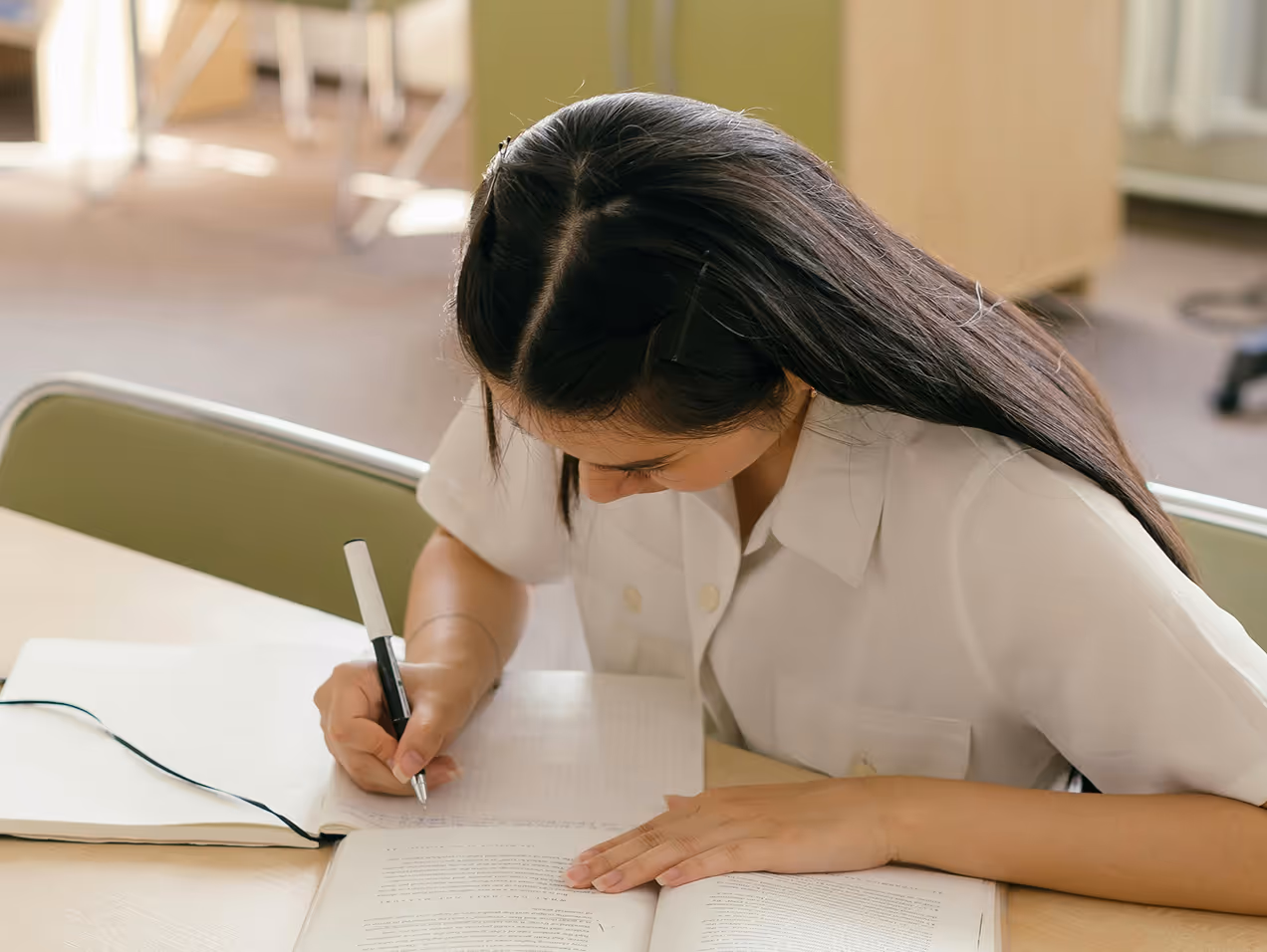 A student writing something in a notebook