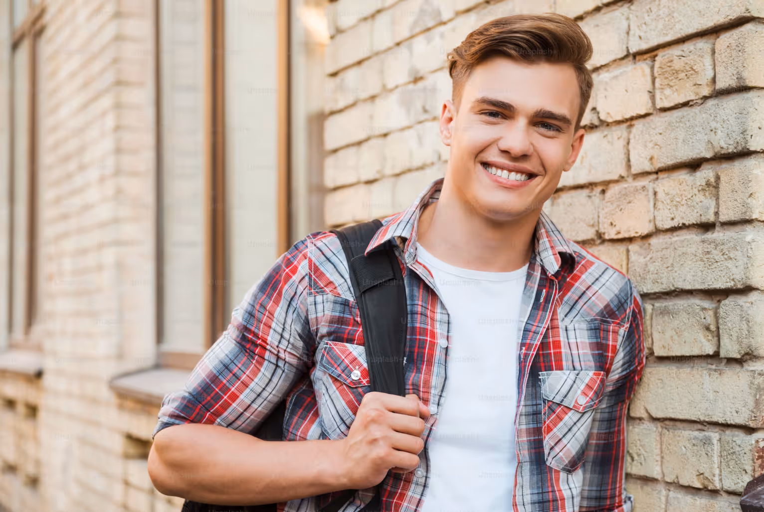 A young man wearing a backpack