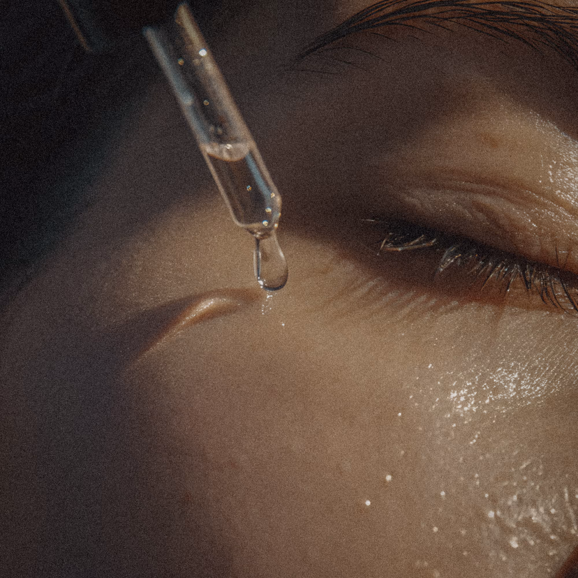 A close up of a person's eye with a needle in it.