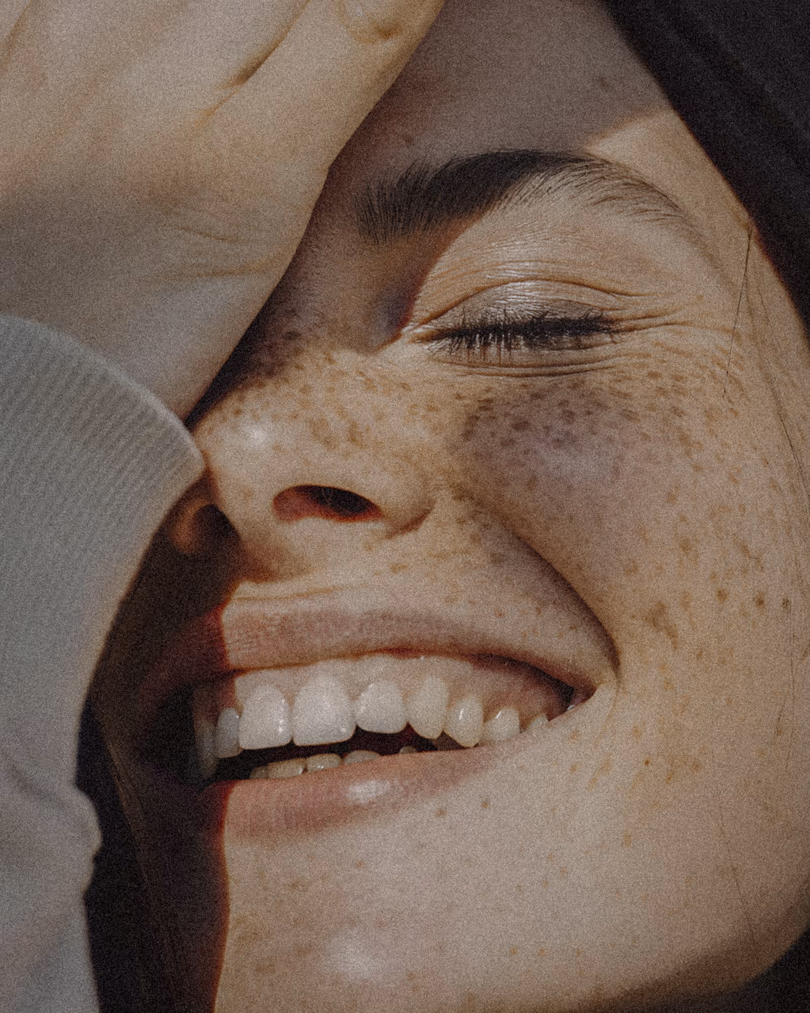 A close up of a person with freckled hair.