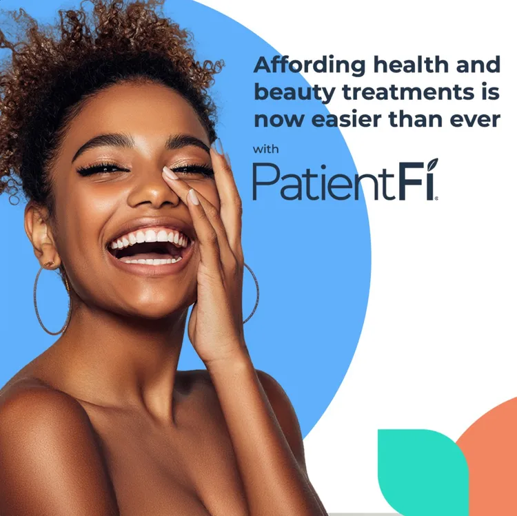 A woman smiling with her hands on her face.