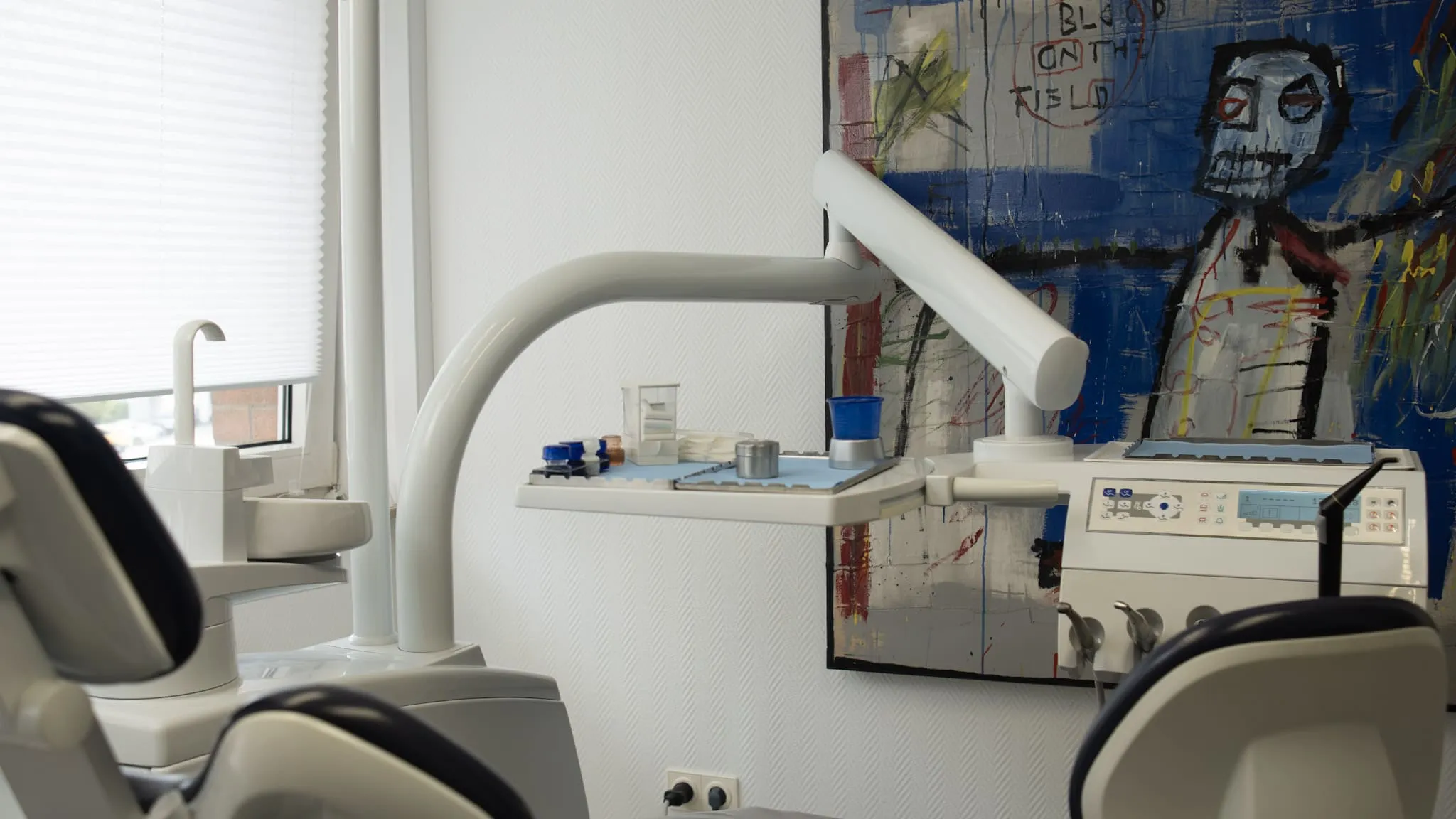 Moderner Behandlungsraum einer Zahnarztpraxis mit heller Einrichtung und moderner Behandlungseinheit.