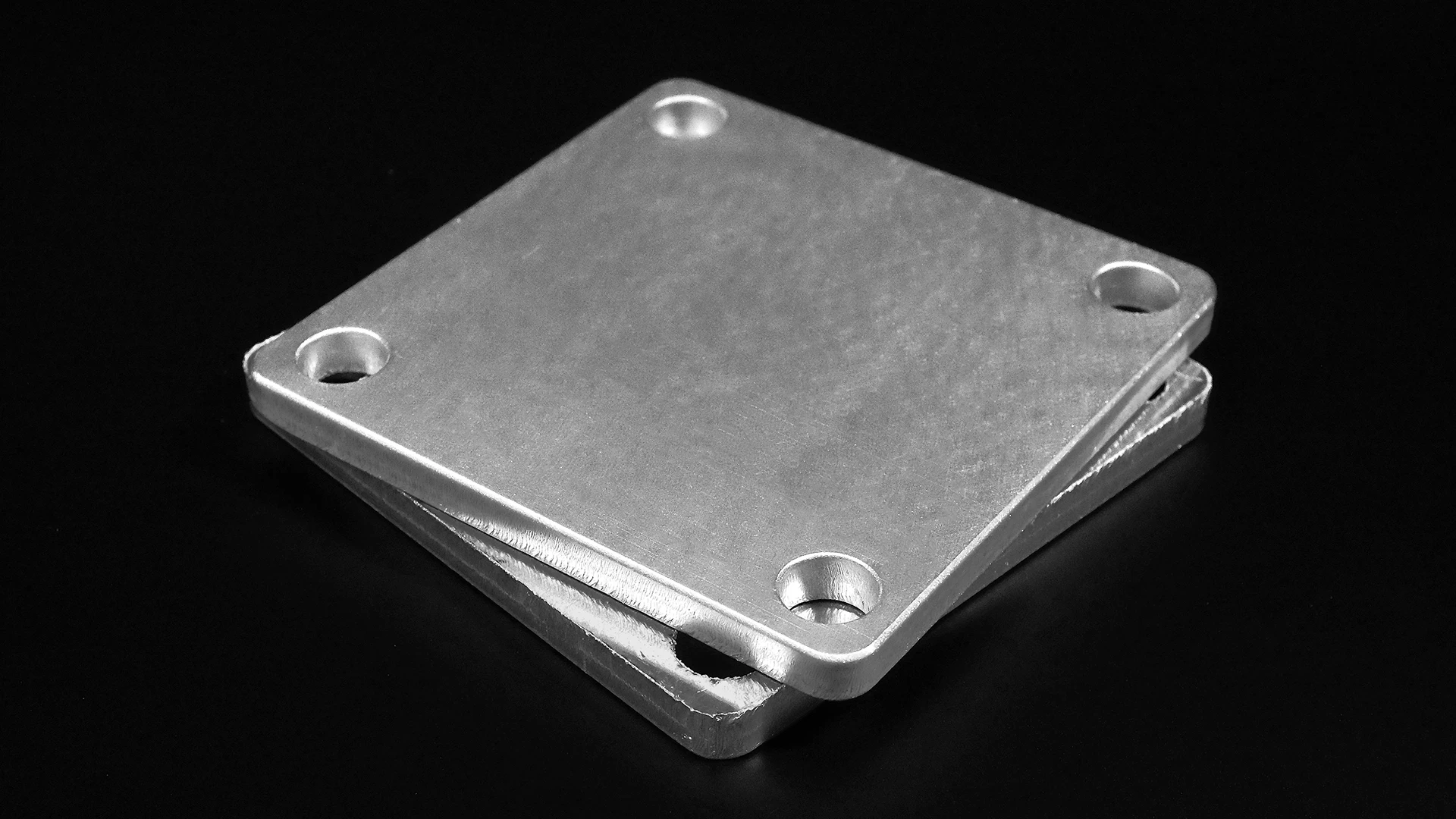 A perfected processed workpiece laying on top of a unfinished workpiece