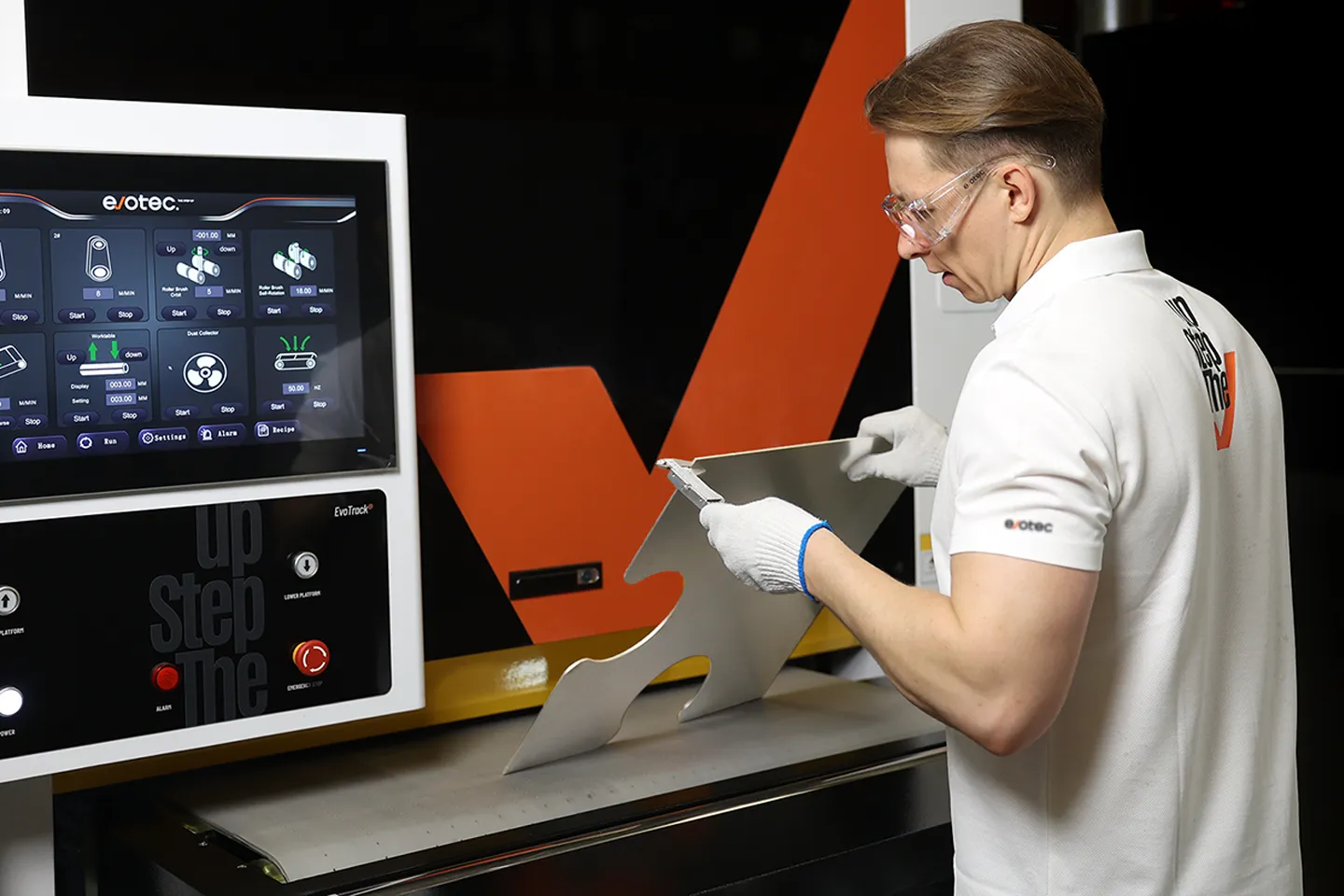 A factory engineer measuring a large workpiece before feeding in the workpiece for deburring
