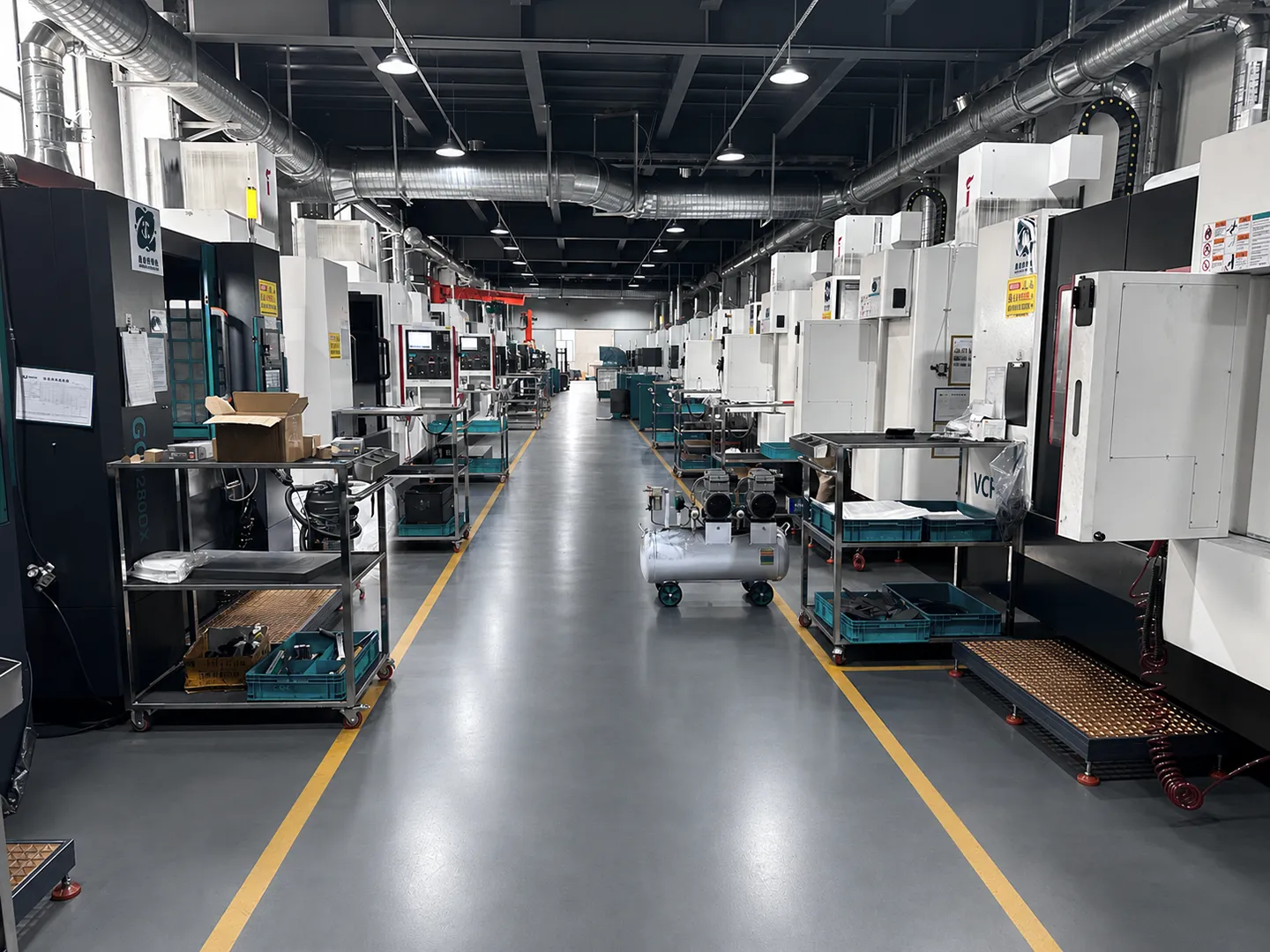 Graphite machining equipment lined up on Max Graphite's factory floor
