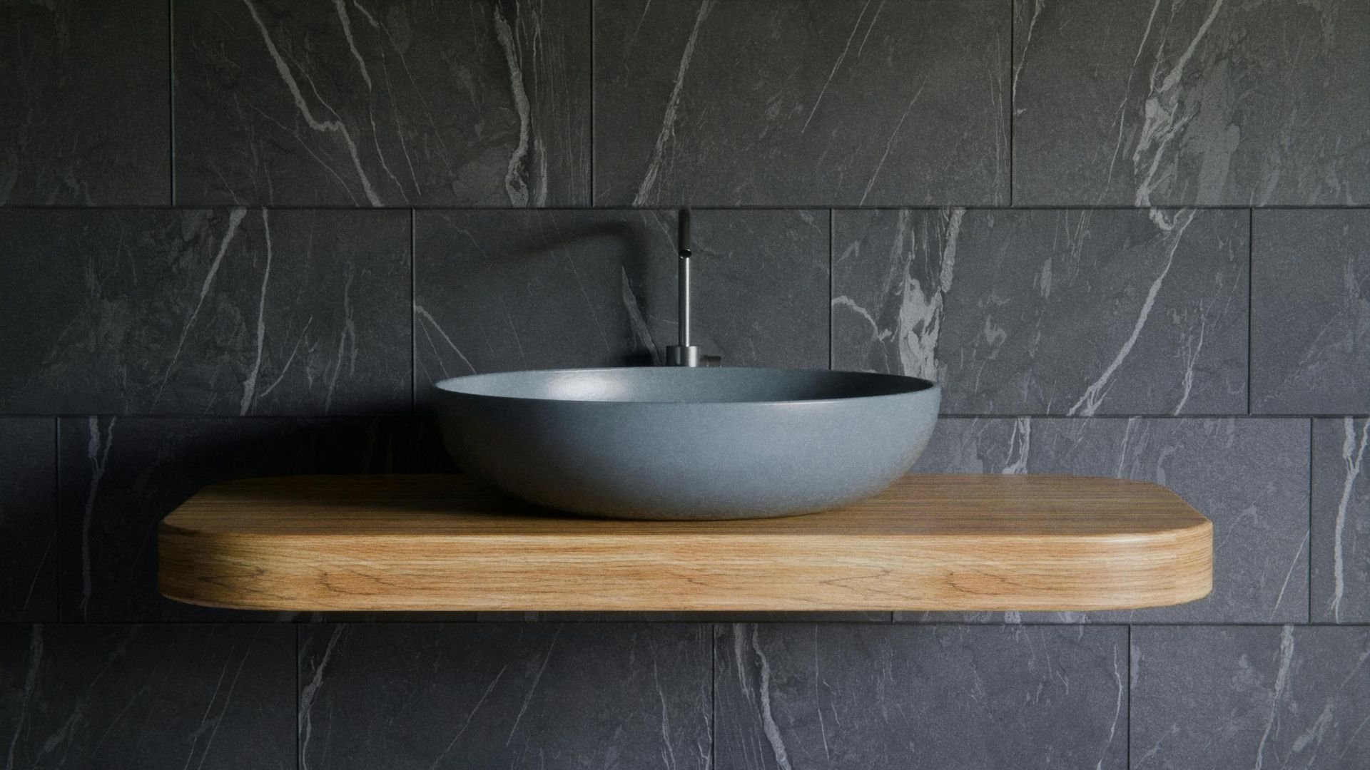 A modern black tiled wall with a sink
