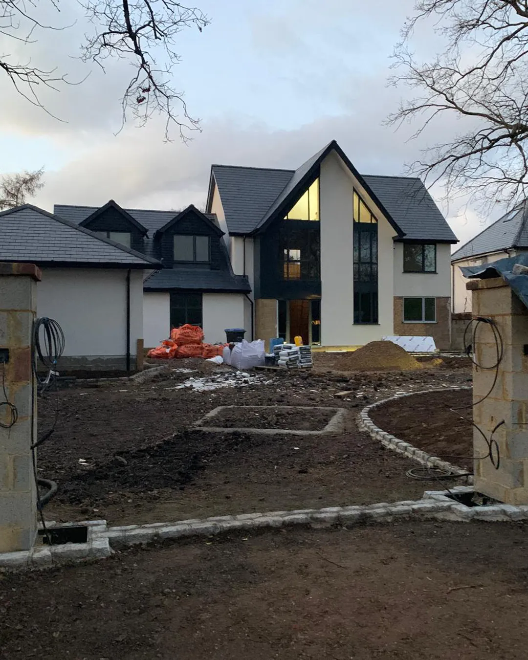 A house being built in the middle of a field.