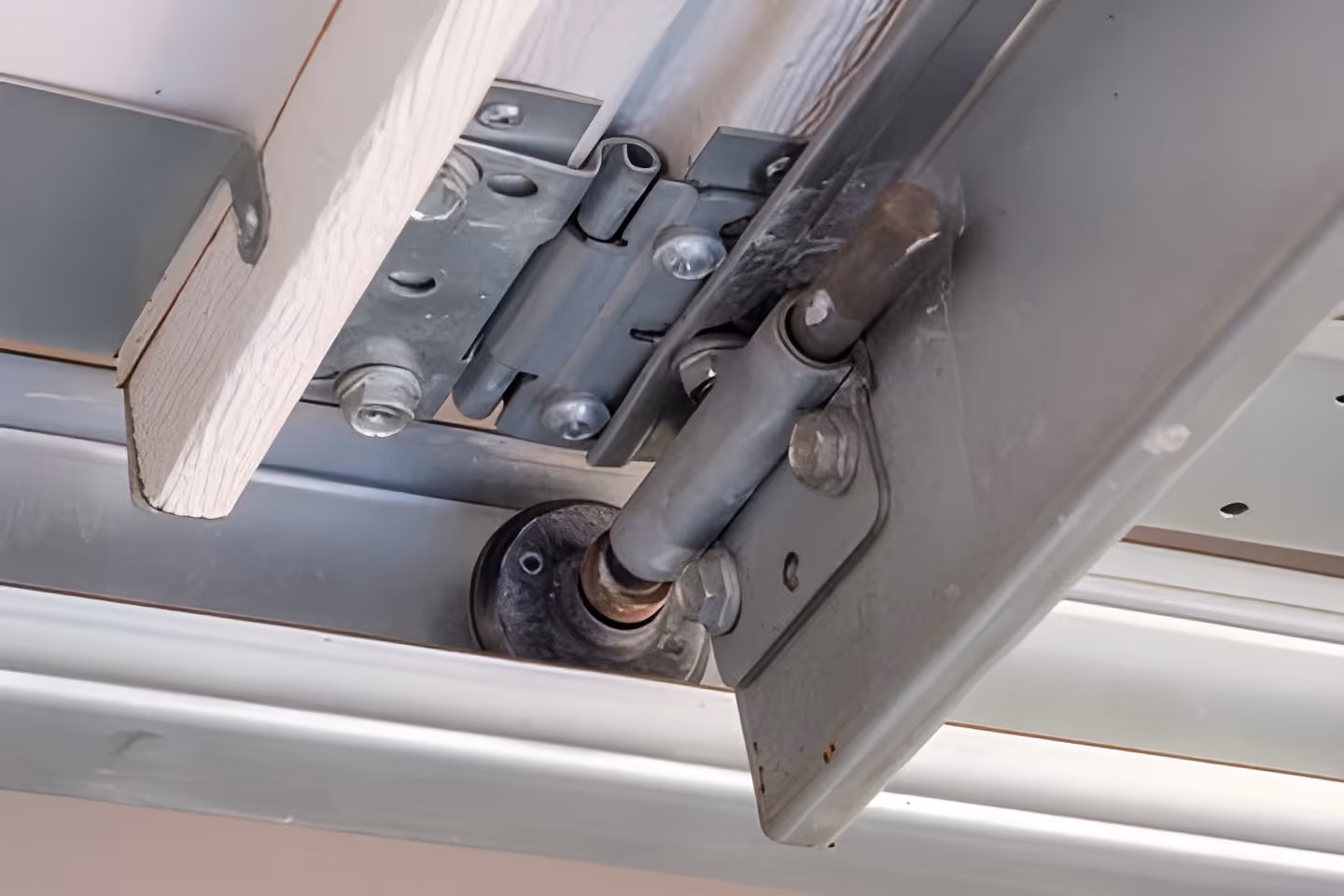 Garage door track with bent or misaligned roller bracket.