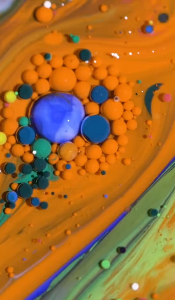 colour droplets like a lava lamp, mainly orange but with blues and greens.