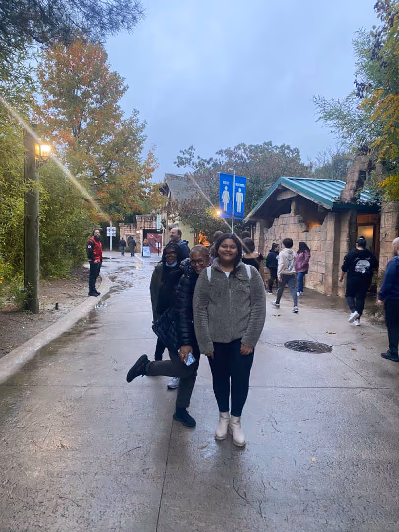 Students walking together outdoors on a rainy day.
