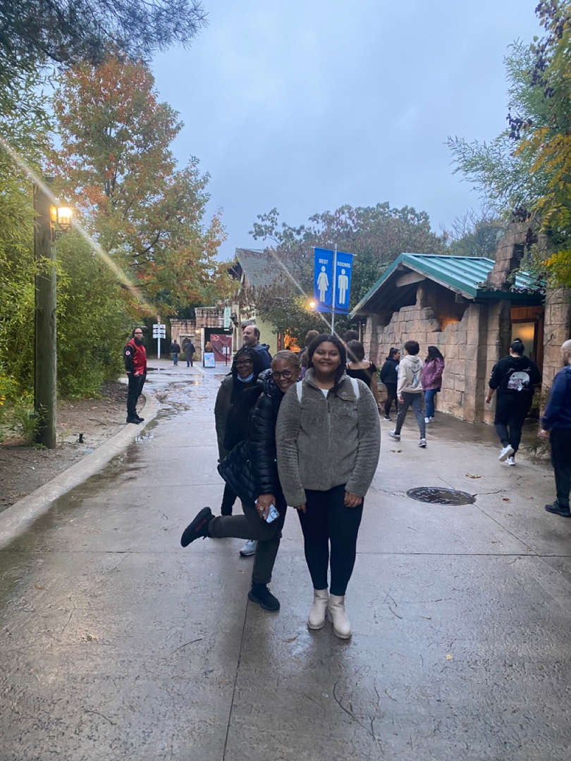 Students walking together outdoors on a rainy day.