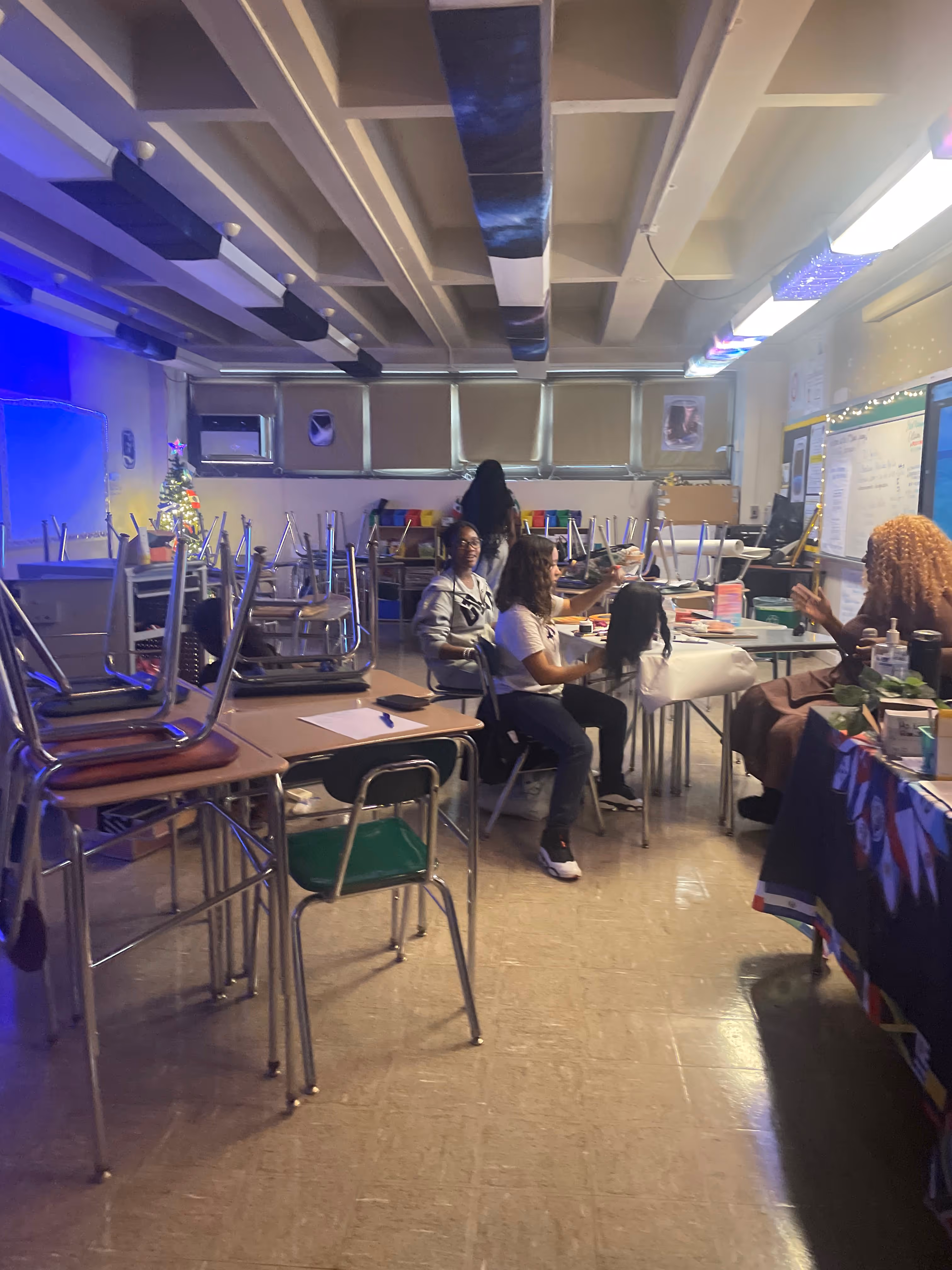 Students working together at tables in classroom during Cosmetology Club