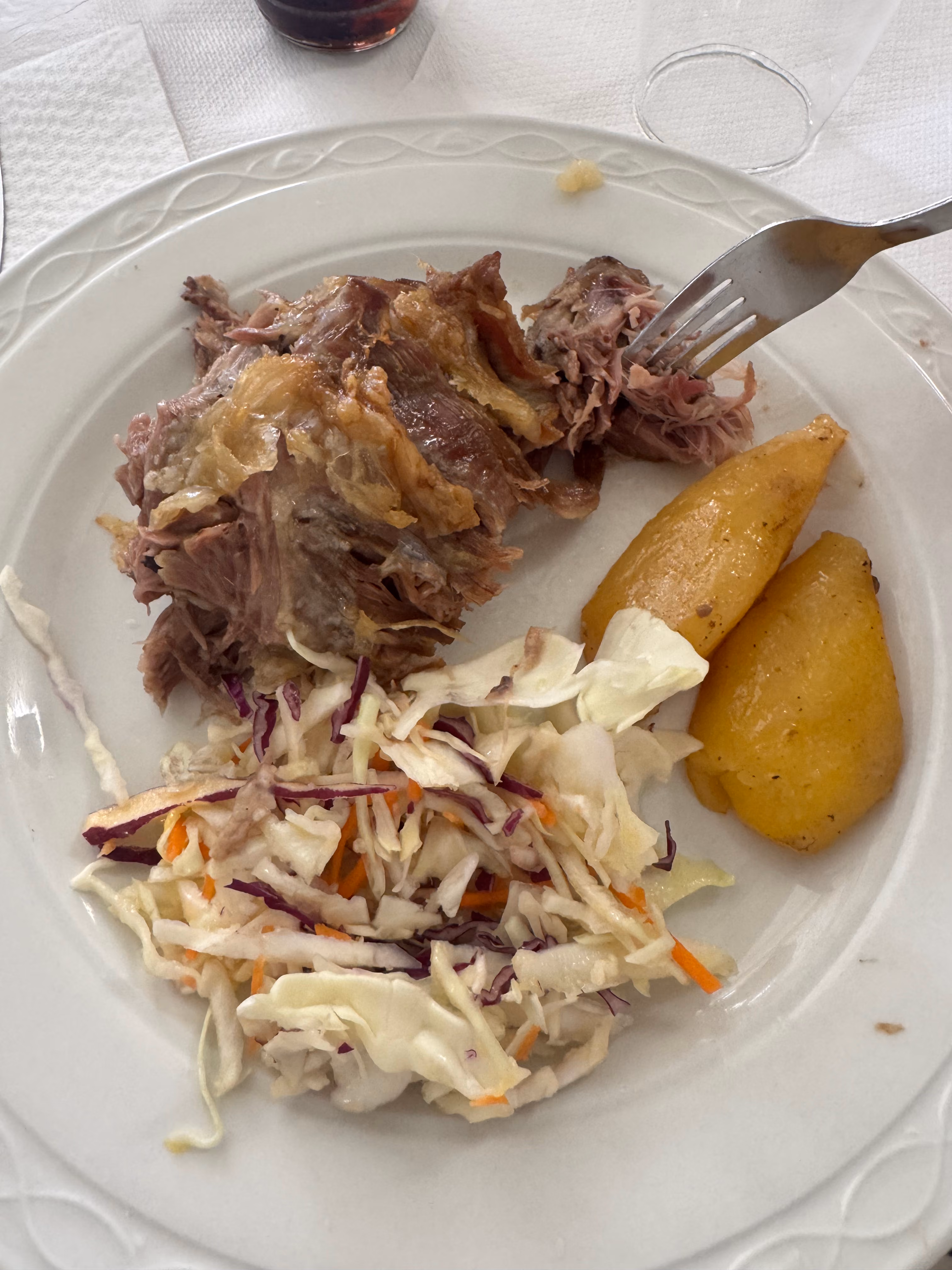 Plate of pulled pork with coleslaw and roasted potatoes