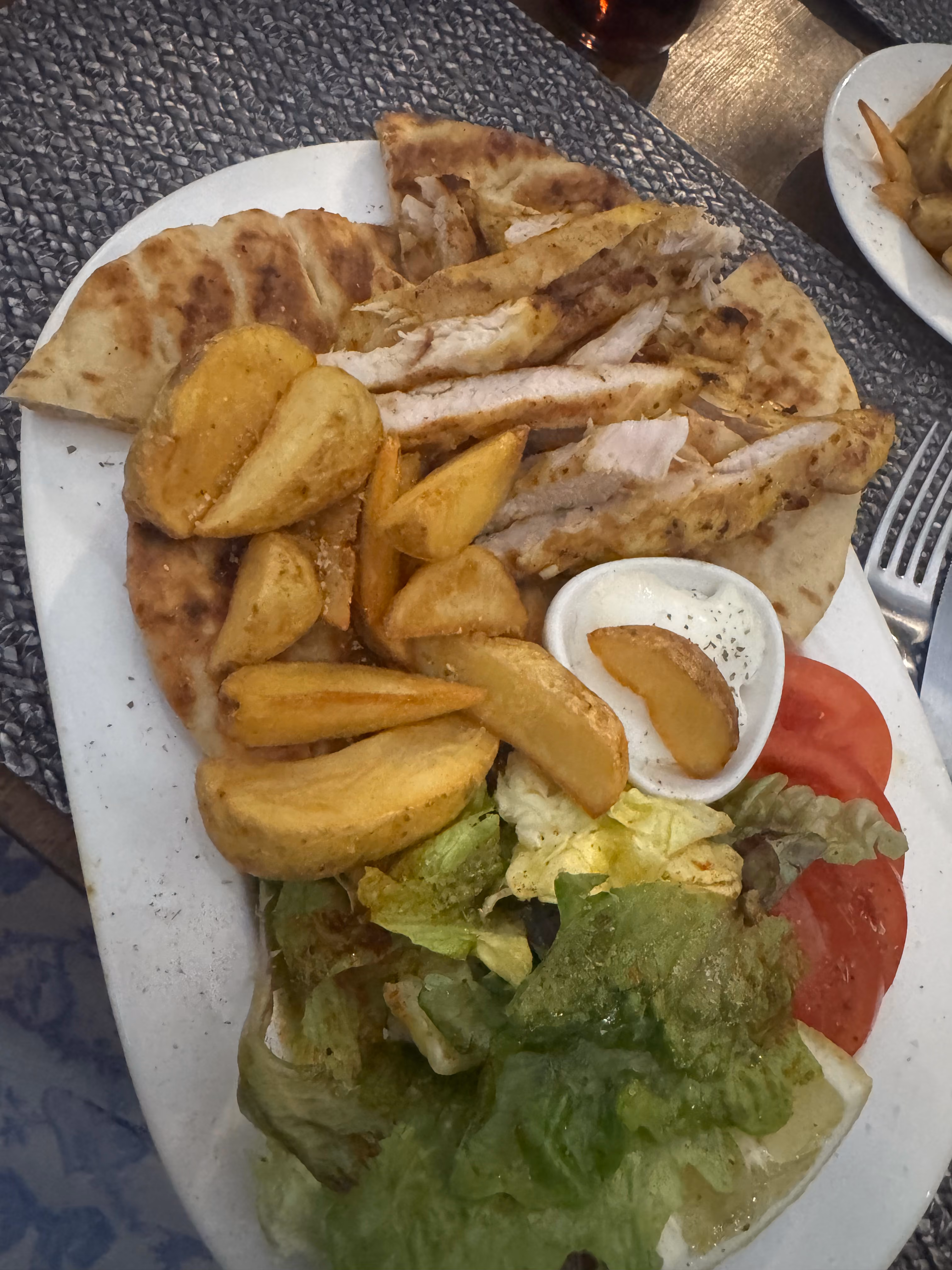 Grilled chicken platter with potato wedges and salad