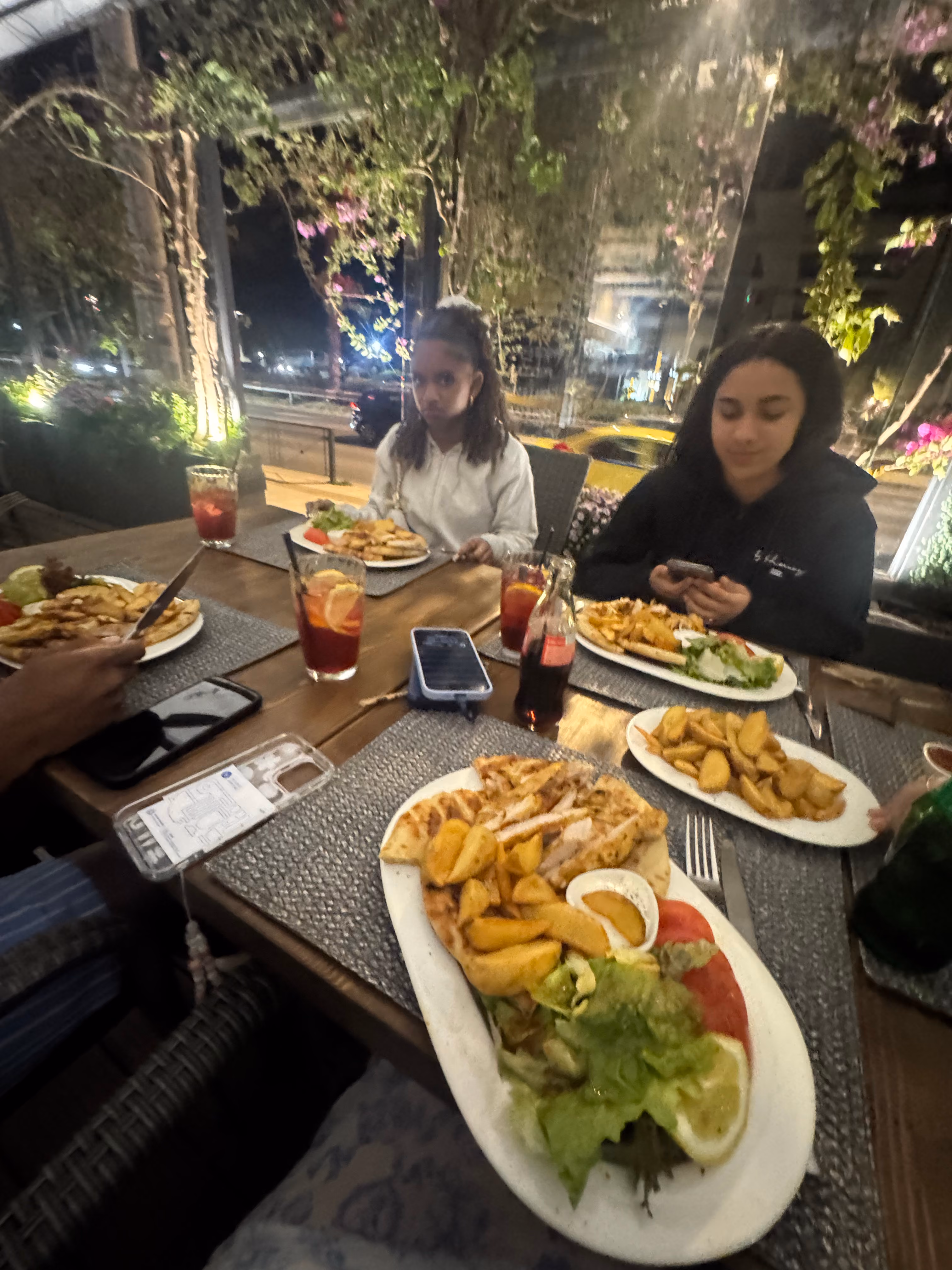 Students sharing a meal together at outdoor restaurant