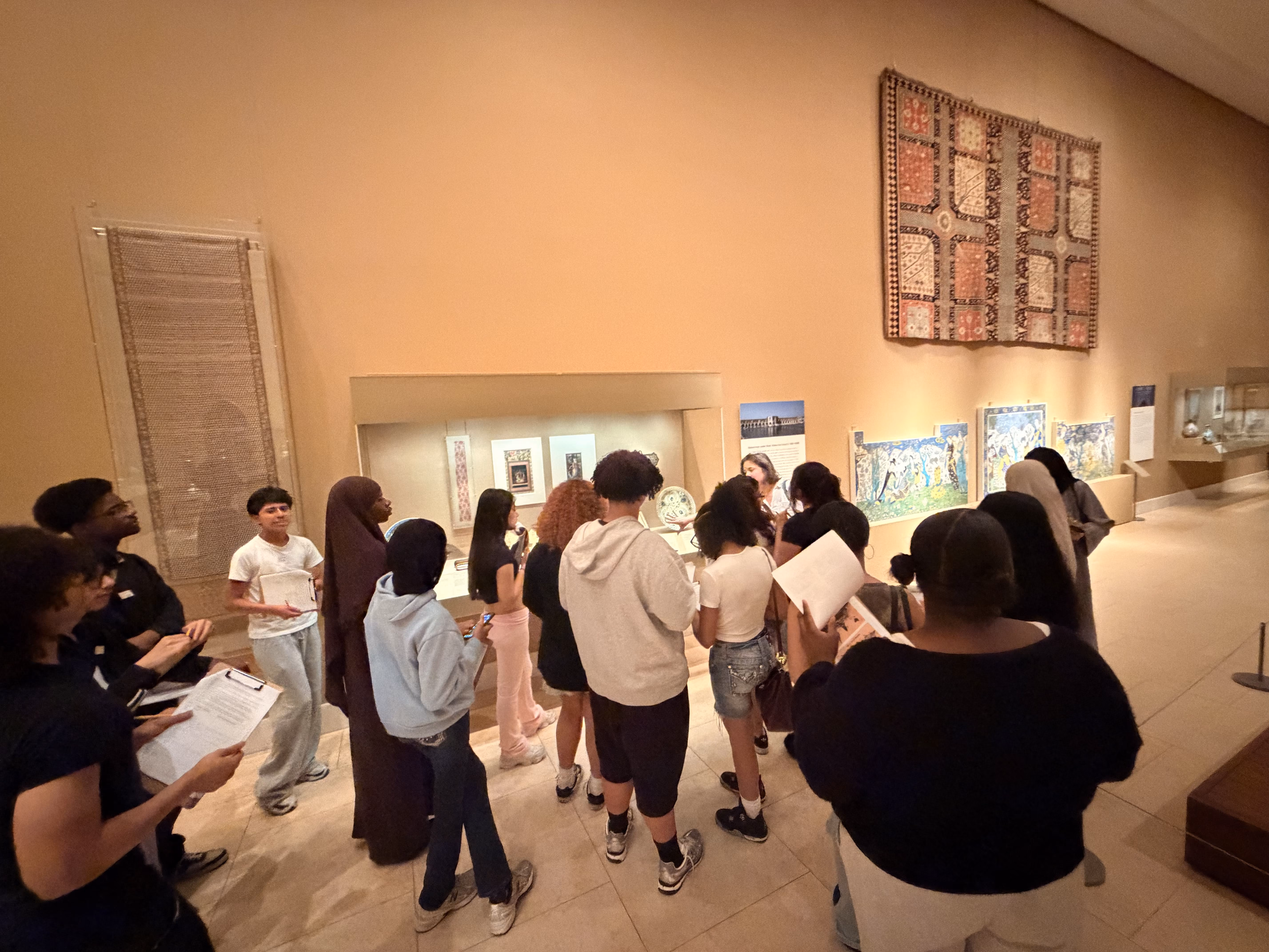 Students on guided tour viewing museum art exhibits