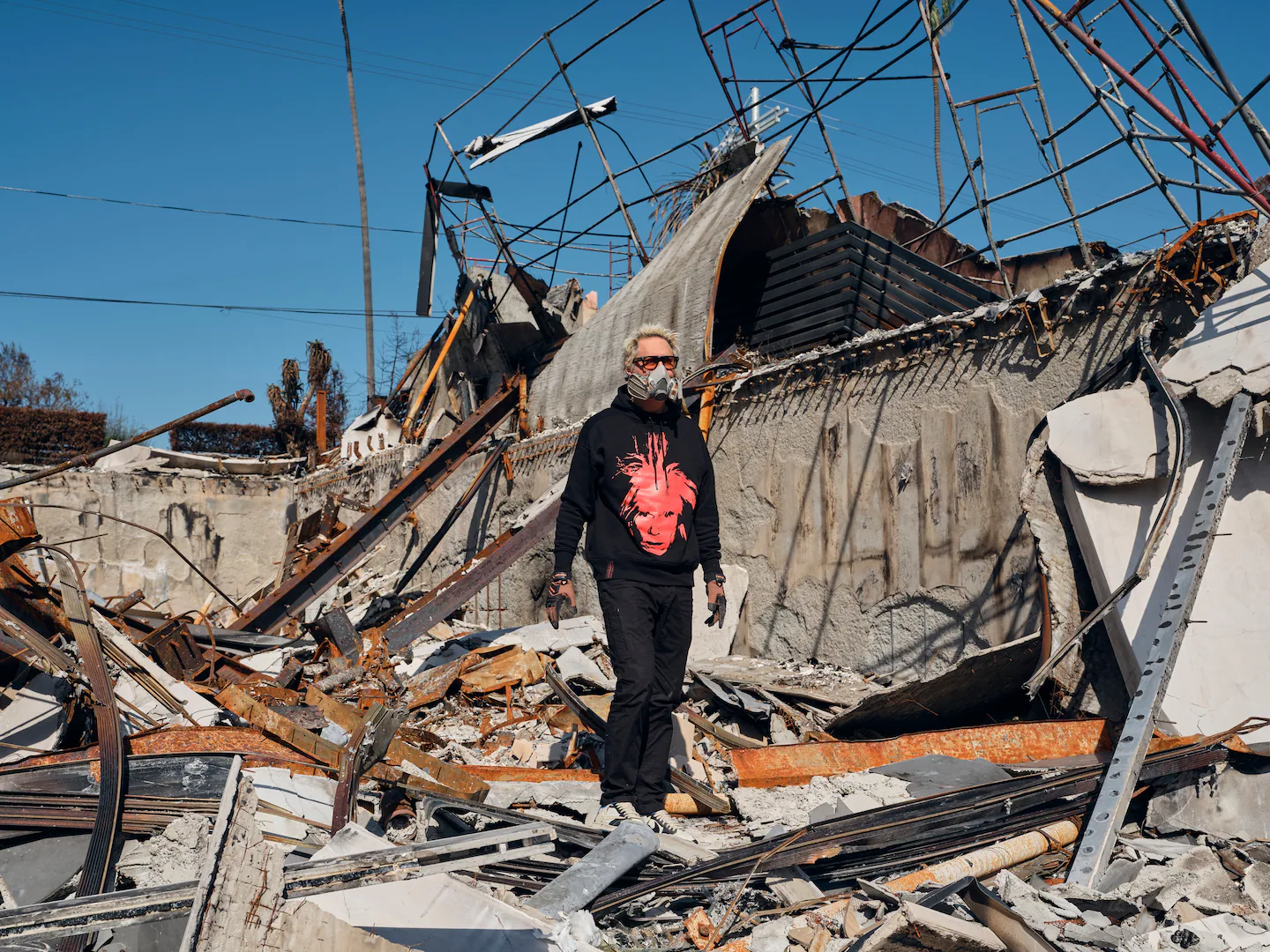 Rivlin searches through the debris of his destroyed home in Pacific Palisades. (Philip Cheung/For The Washington Post)