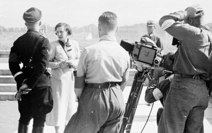 Riefenstahl standing near Heinrich Himmler while directing her camera crew at Nuremberg, 1934.