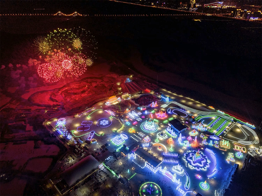 View of fireworks exploding near illuminated ice sculptures. 35th Harbin International Ice and Snow Festival. The Atlantic.