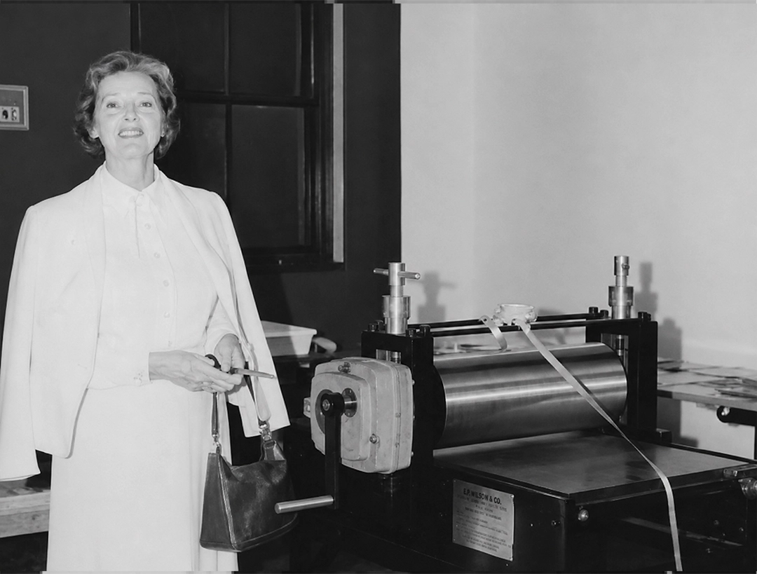 Mayor Bobbie Stern cuts the ribbon on the new Charles Brand etching press.