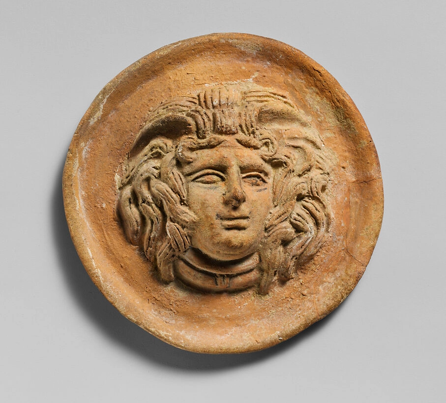 Greek terracotta roundel with the head of Medusa, Hellenistic period, 2nd century BCE. The Metropolitan Museum of Art, New York.