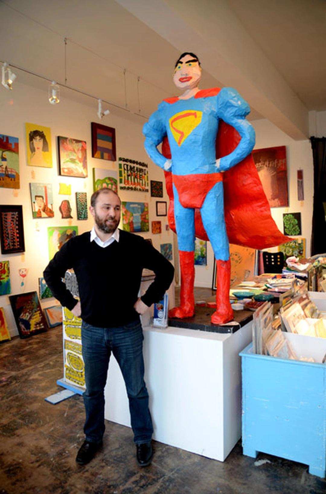 Matt Distel with giant Superman sculpture created by Visionaries and Voices artists, Cincinnati.