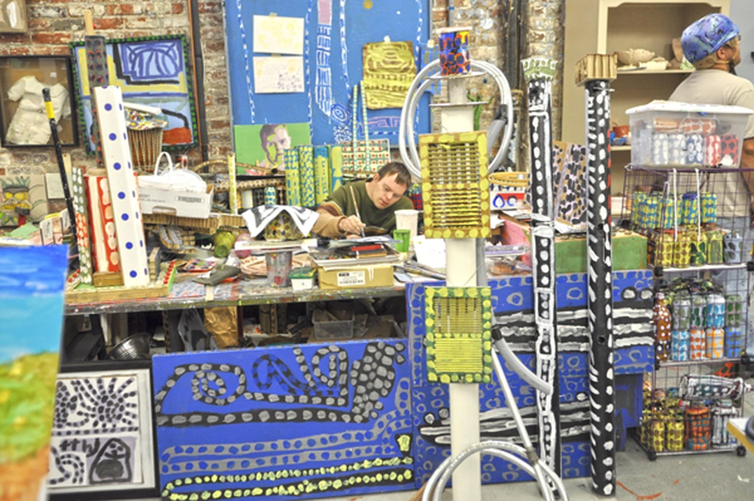 Artists creating paintings and sculptures in the Visionaries and Voices studio, Cincinnati.