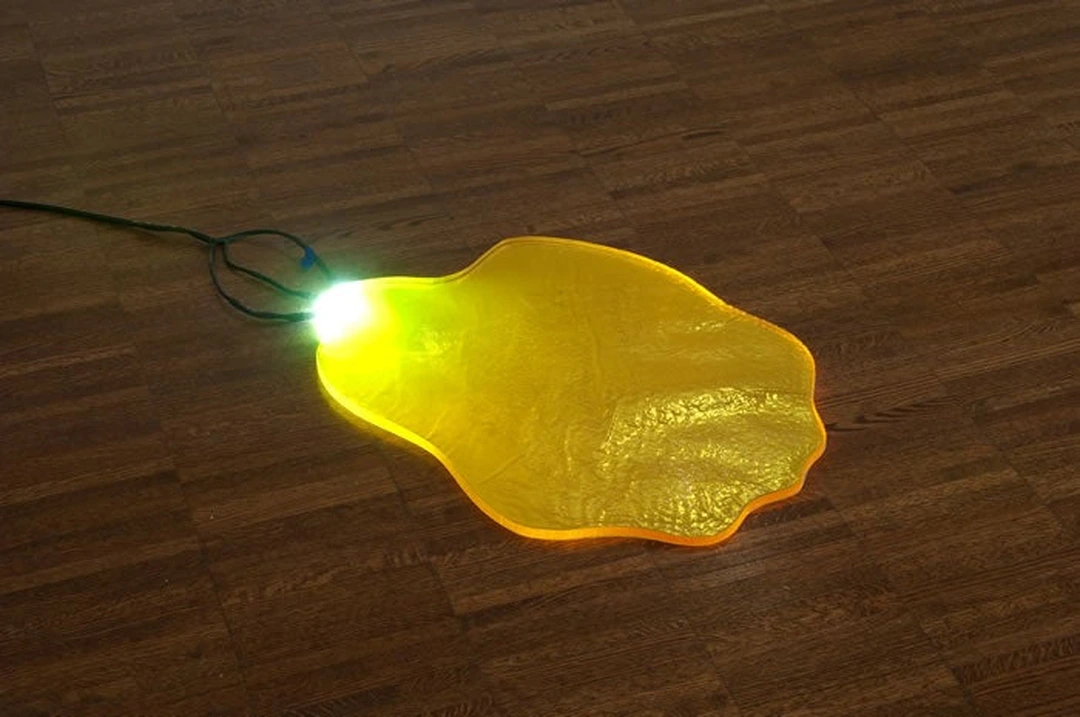 Chris Vorhees, floor lamp, 2011, polyester resin puddle with LED lights at the Weston Art Gallery.