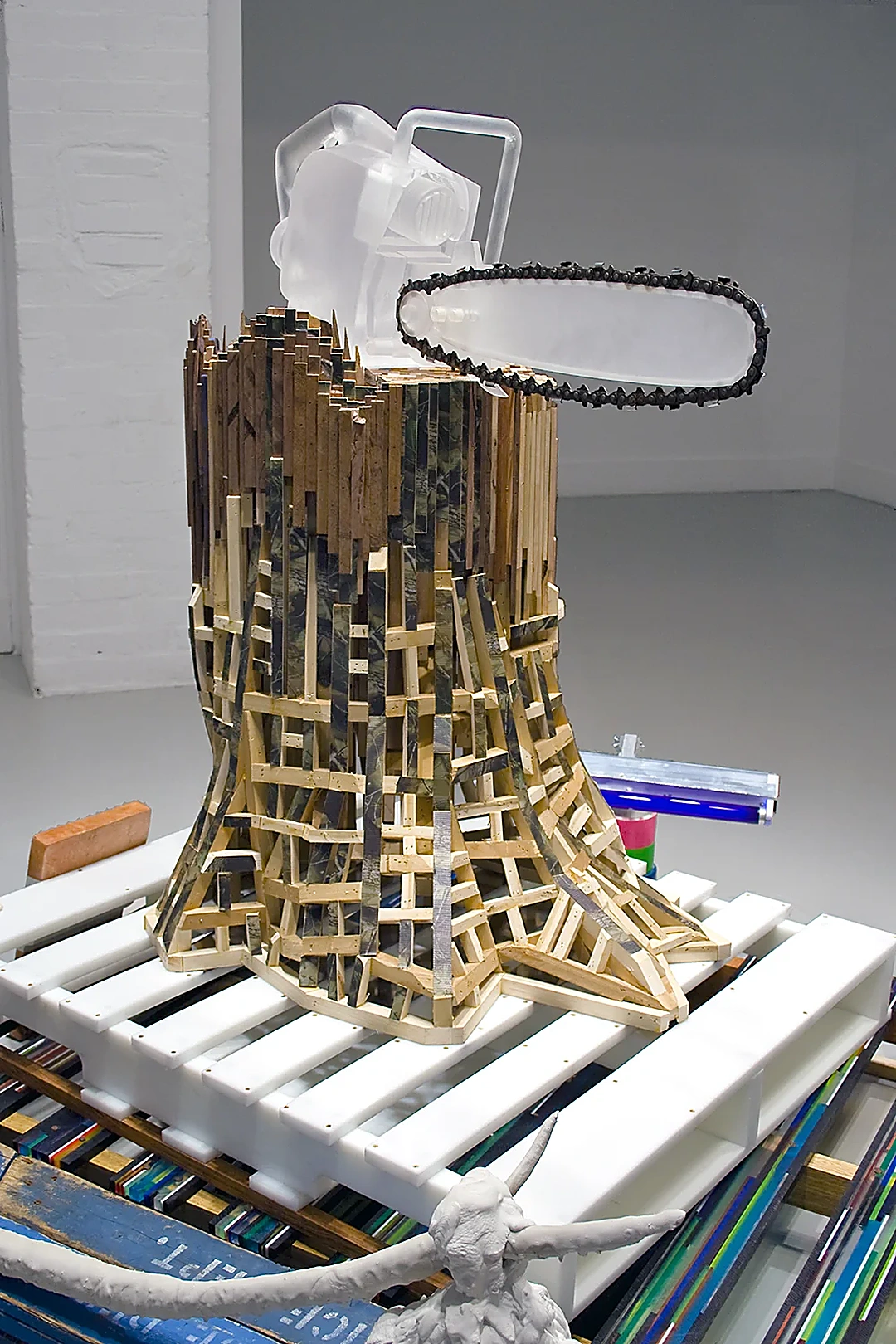 Taylor Baldwin, I Ain’t Afraid of No Ghosts, polyethylene chainsaw, wood stump, plastic pallets, 2009.