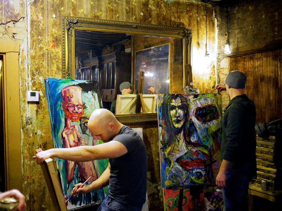 Kurt Einhaus and artist live painting during the opening reception of Die Cupid Die at The Famous Neons Unplugged