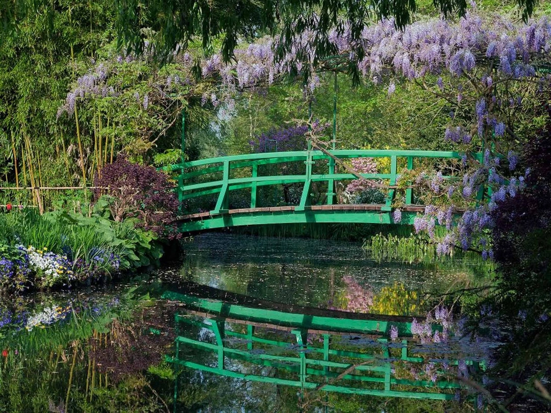 The green Japanese bridge reflected in the water garden at Giverny.